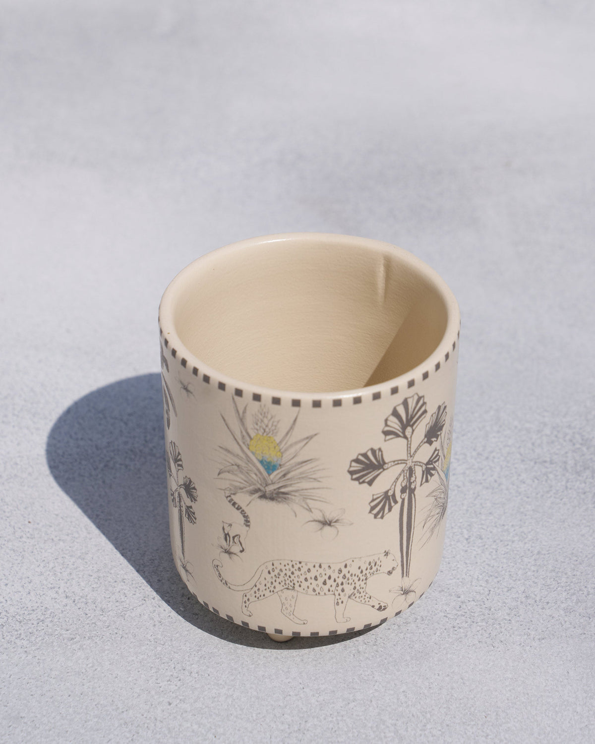 High-angle view of a Monchrome planter with leopard and tropical print.