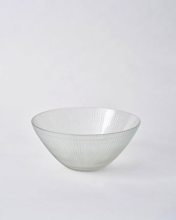 Aire Serving Bowl in clear glass with fine vertical ridges.