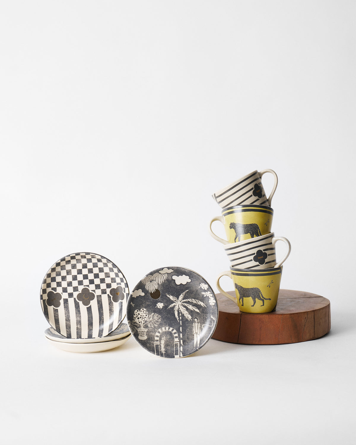 Moonlight tea set of yellow leopard mugs and black-and-white tea plates.