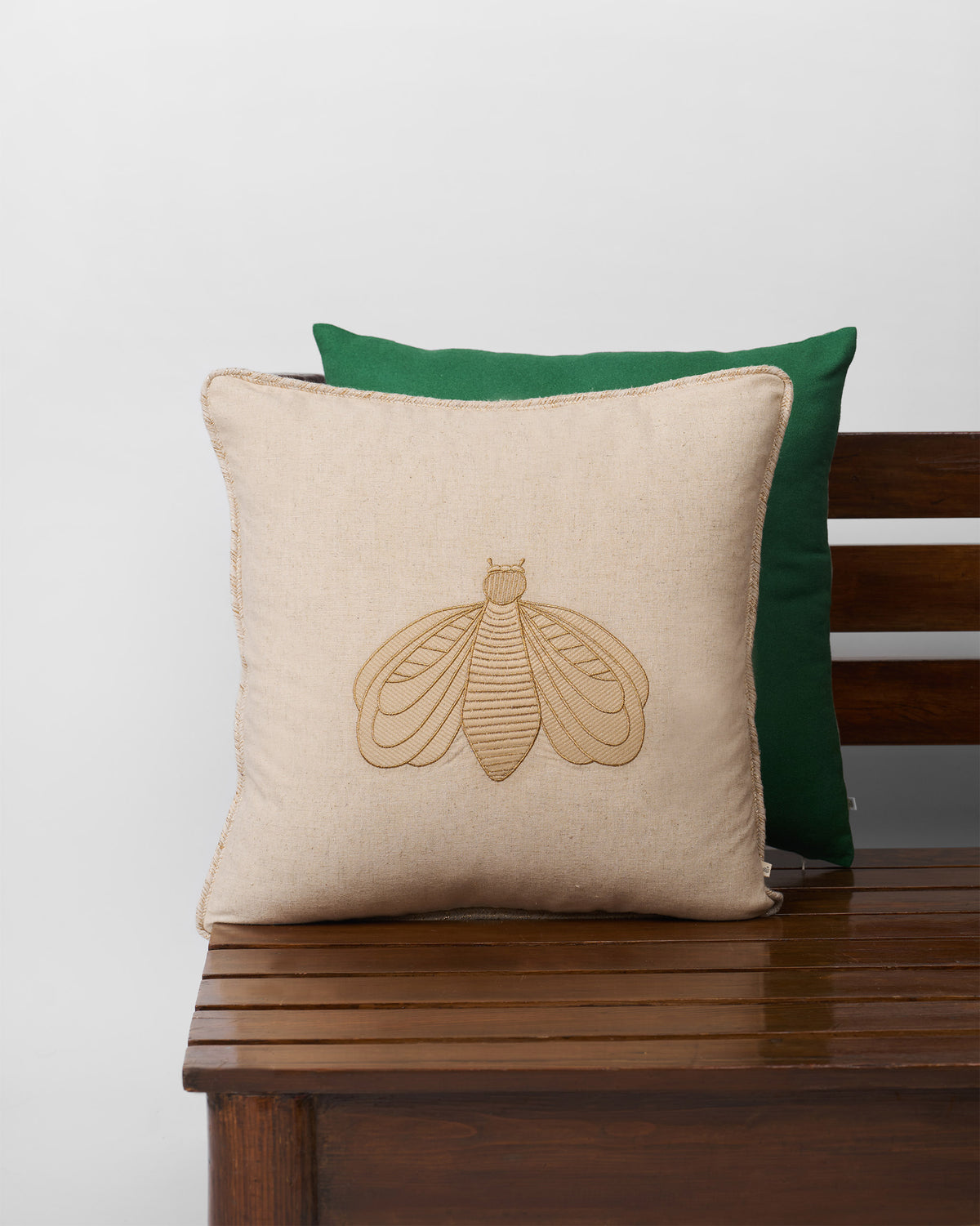 Bumble Bee Cushion Cover with an embroidered bee on beige fabric.