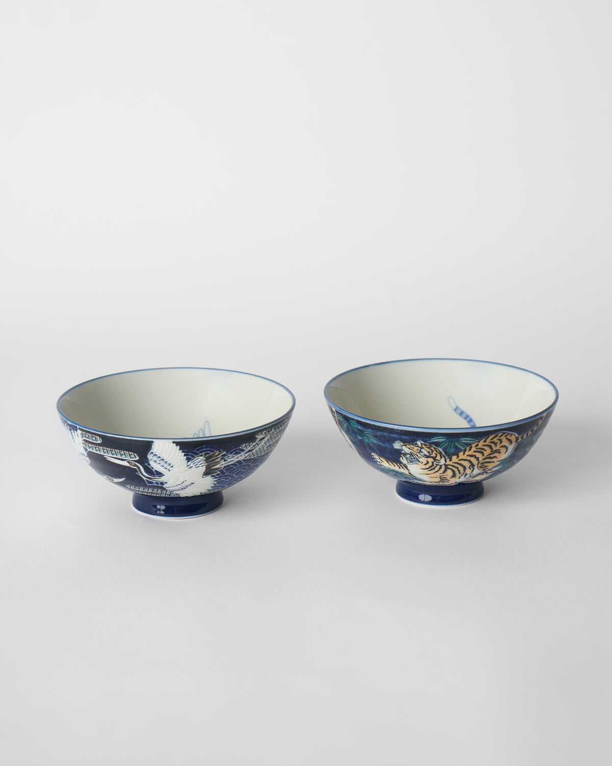 Pair of blue Crane and Tiger Bowls with a white crane and orange tiger.