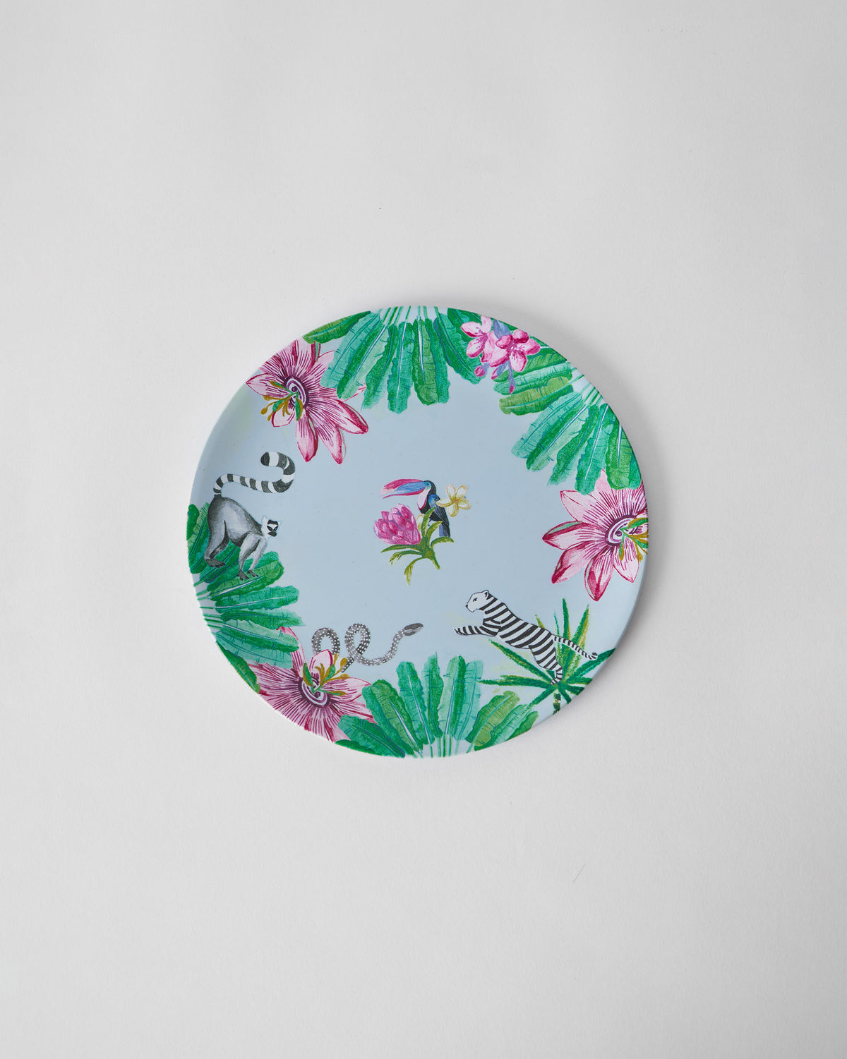 Top view of a Toucan Bamboo quarter Plate with toucan and lemur motifs.