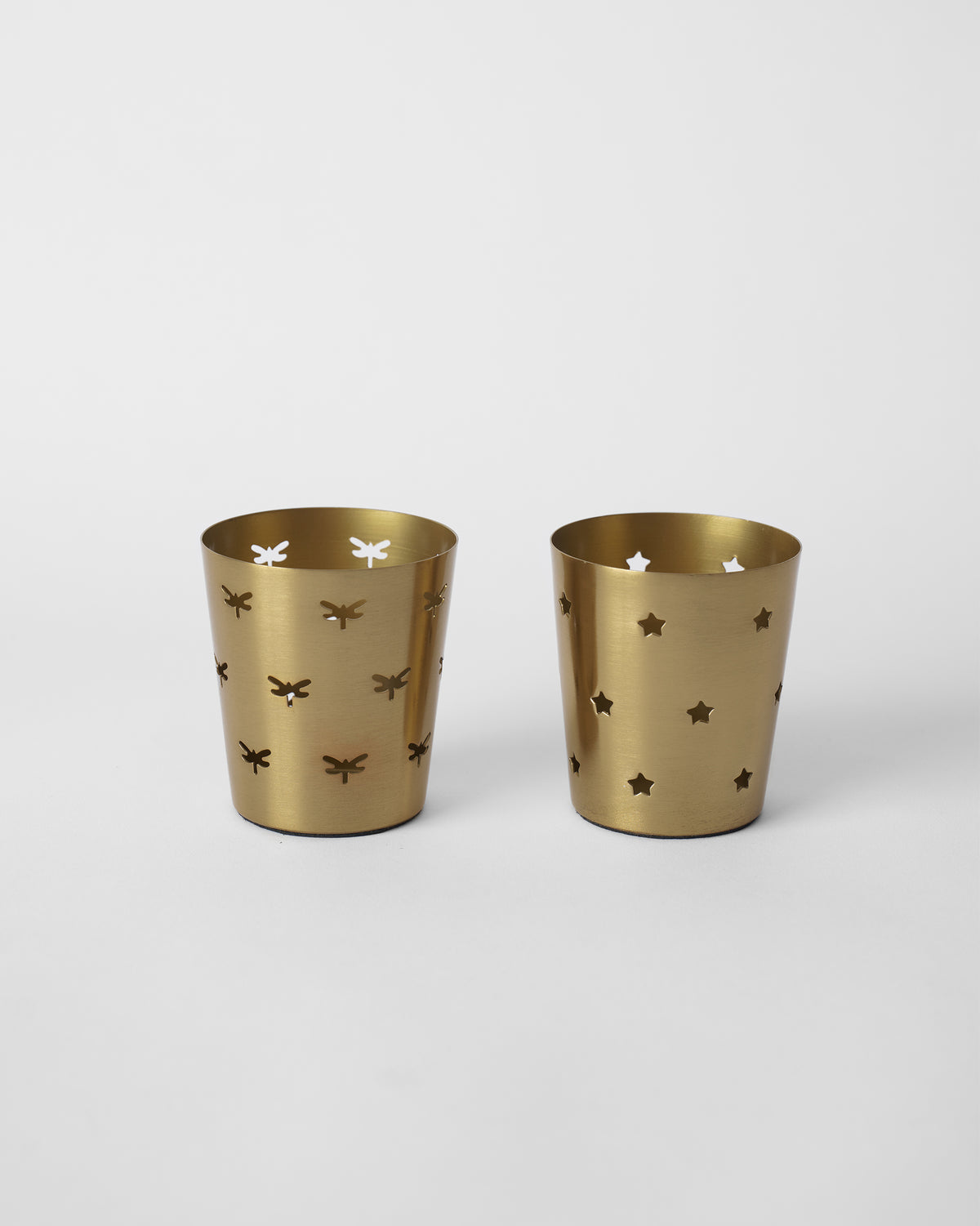Pair of Smriti gold votives with dragonfly and star cutouts.