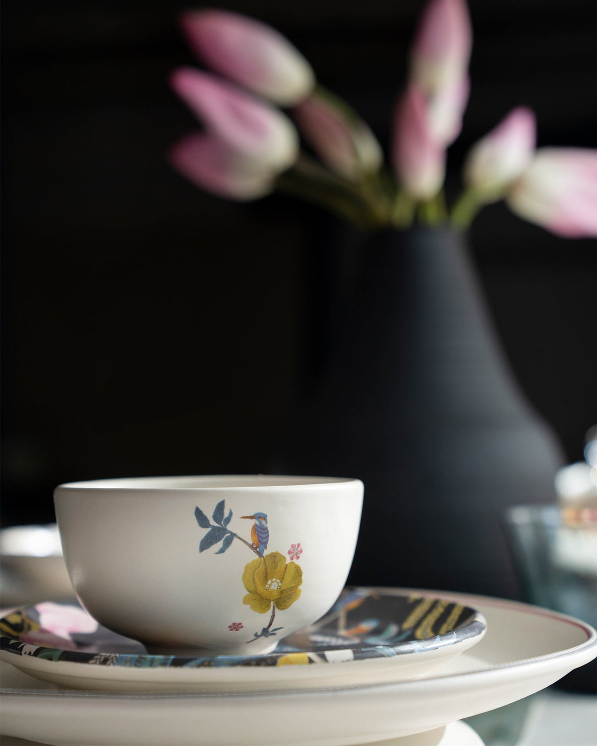 Myra katori with a kingfisher and yellow flower on stacked plates.