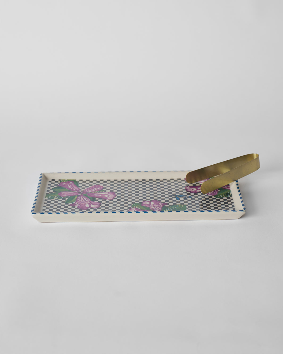Buransh Cookie Tray with purple blooms, a checkered base, and gold tongs.