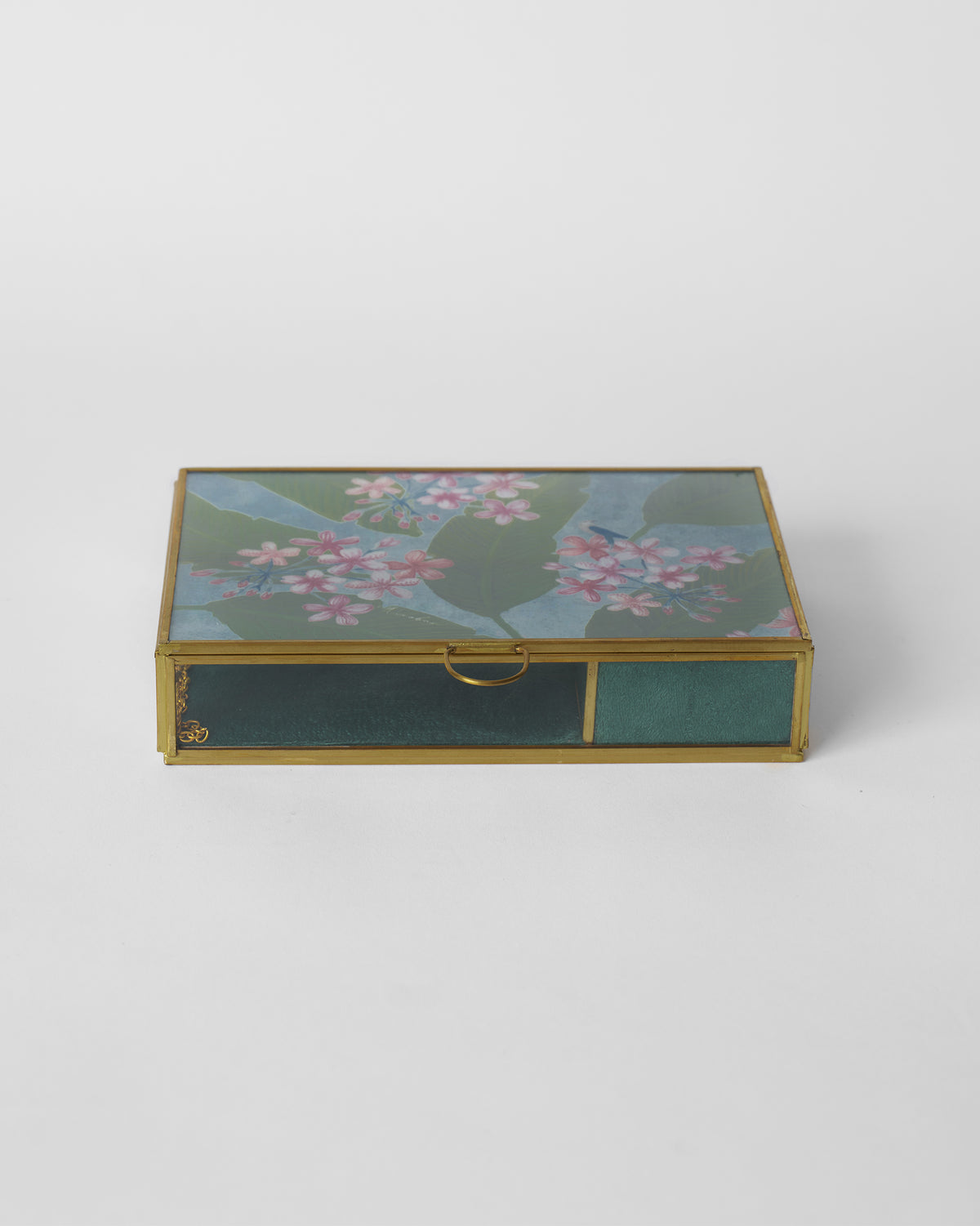Madhumalti Jewellery Box closed, with a floral lid and brass frame.