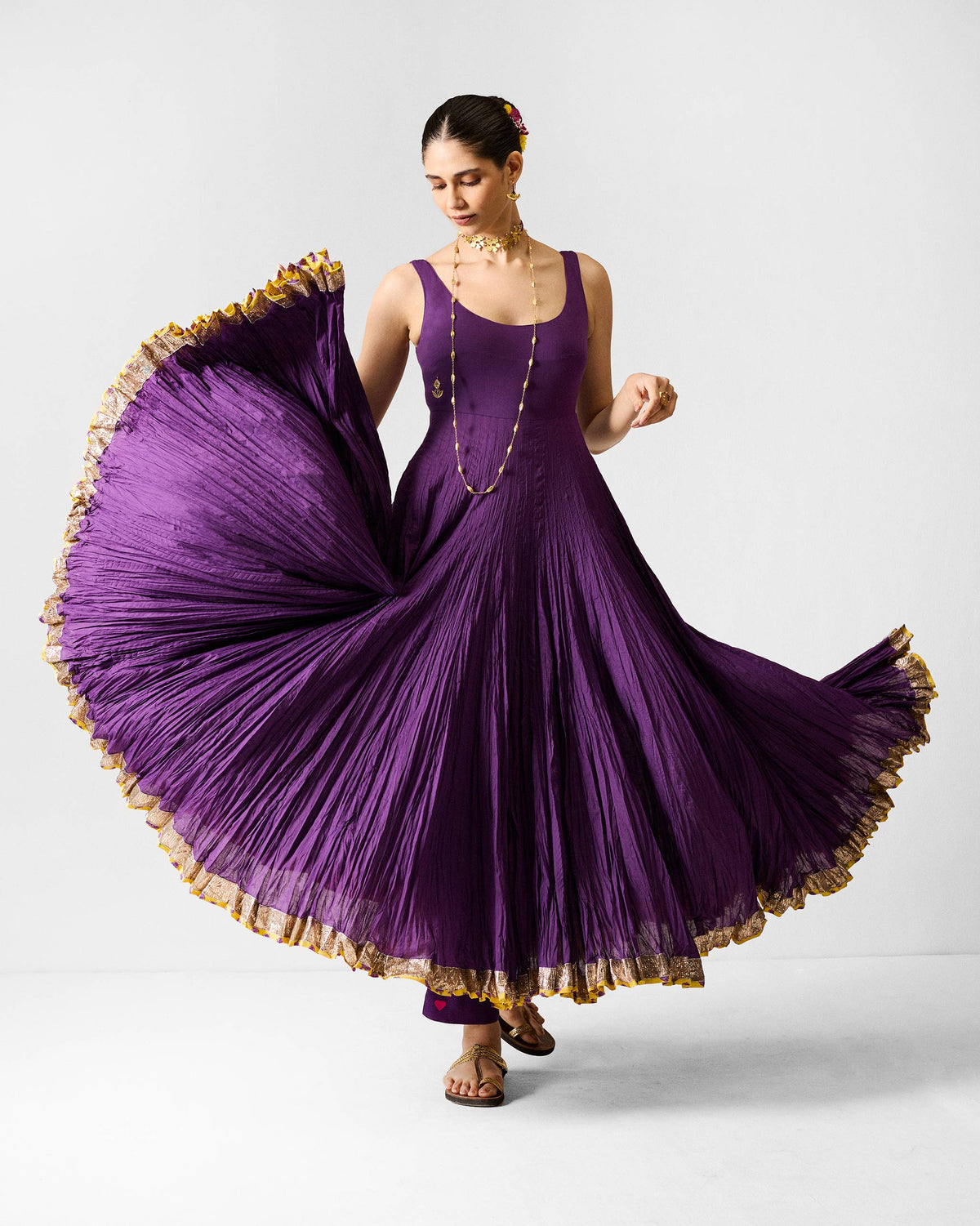 Purple Darjeeling pants worn under a flared purple kurta.