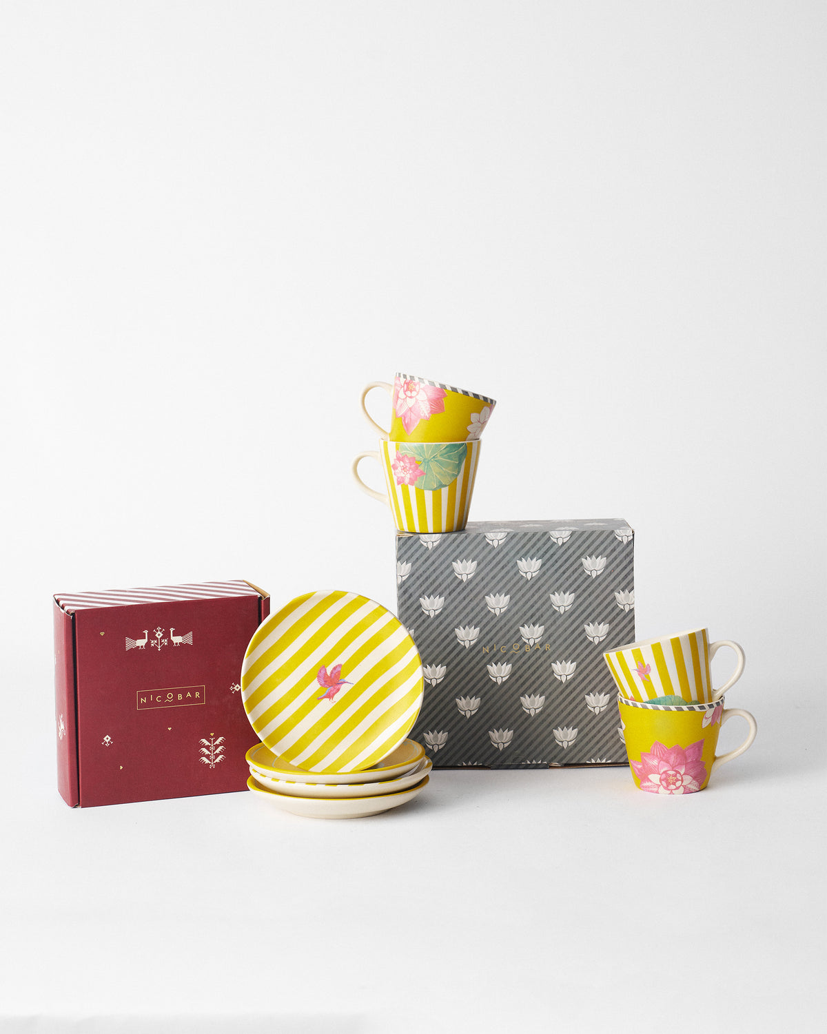 Lotus Garden tea plates stacked beside a red Nicobar gift box.