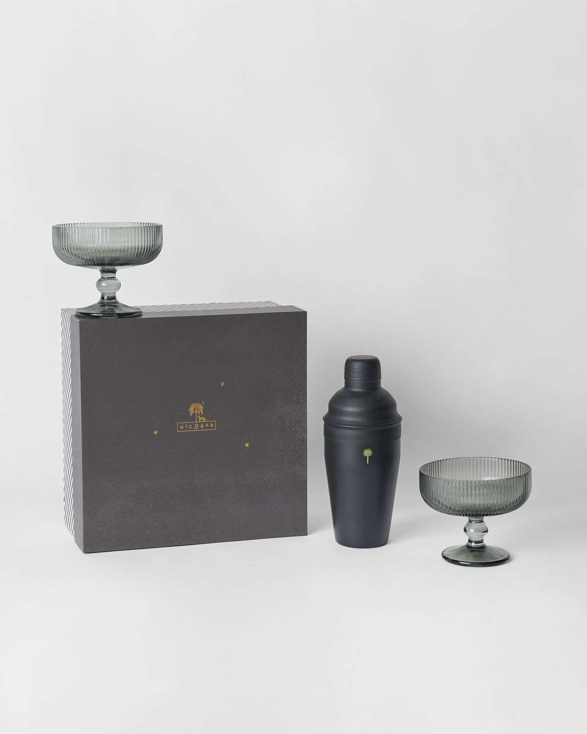 Avi bar gift set with black shaker, smoked coupe glasses and Nicobar gift box.