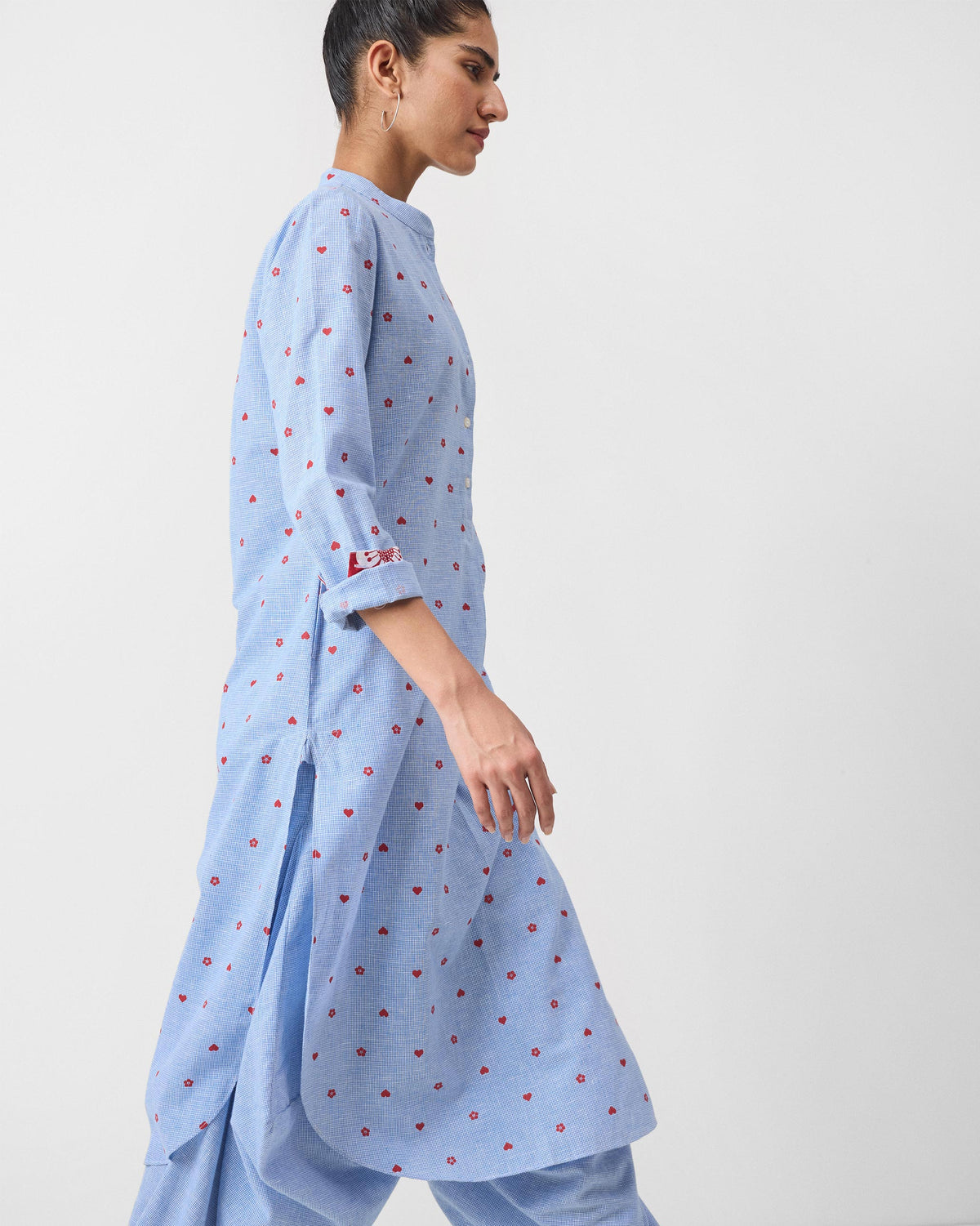 Side view of a light blue Sakura set kurta with red motifs.