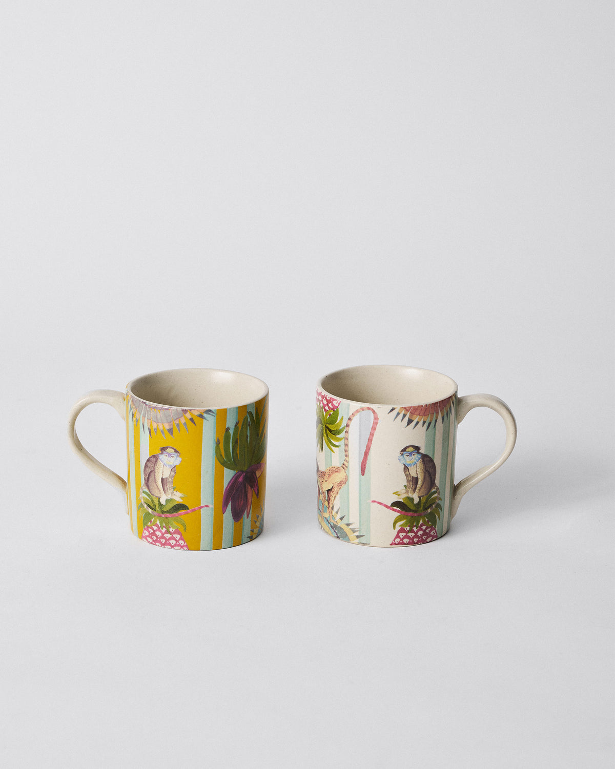 Yellow and ivory Mahi Mugs from the Mahi Mug Set standing side by side.