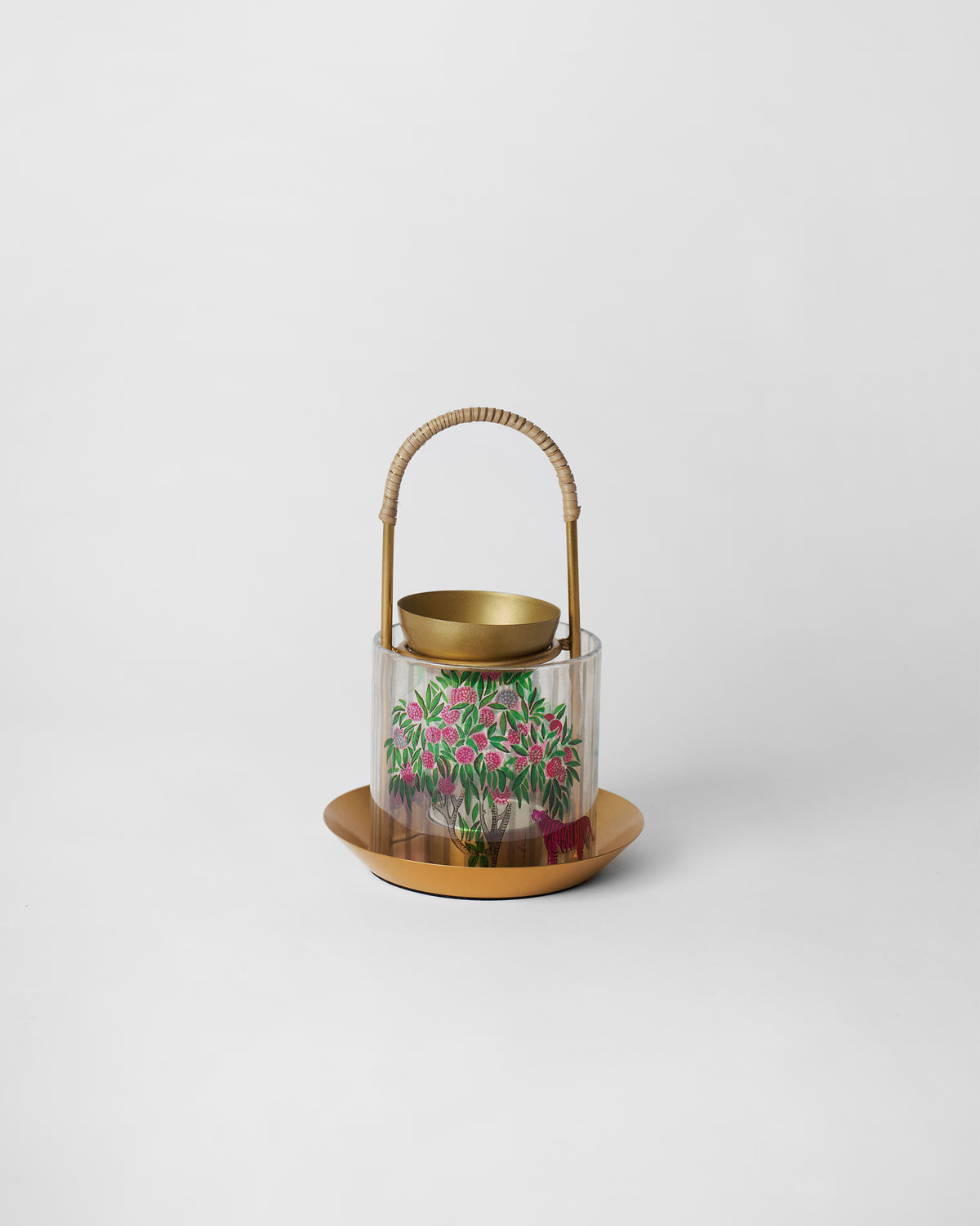 Gold Kandy diffuser with pink tiger glass sleeve and rattan handle.