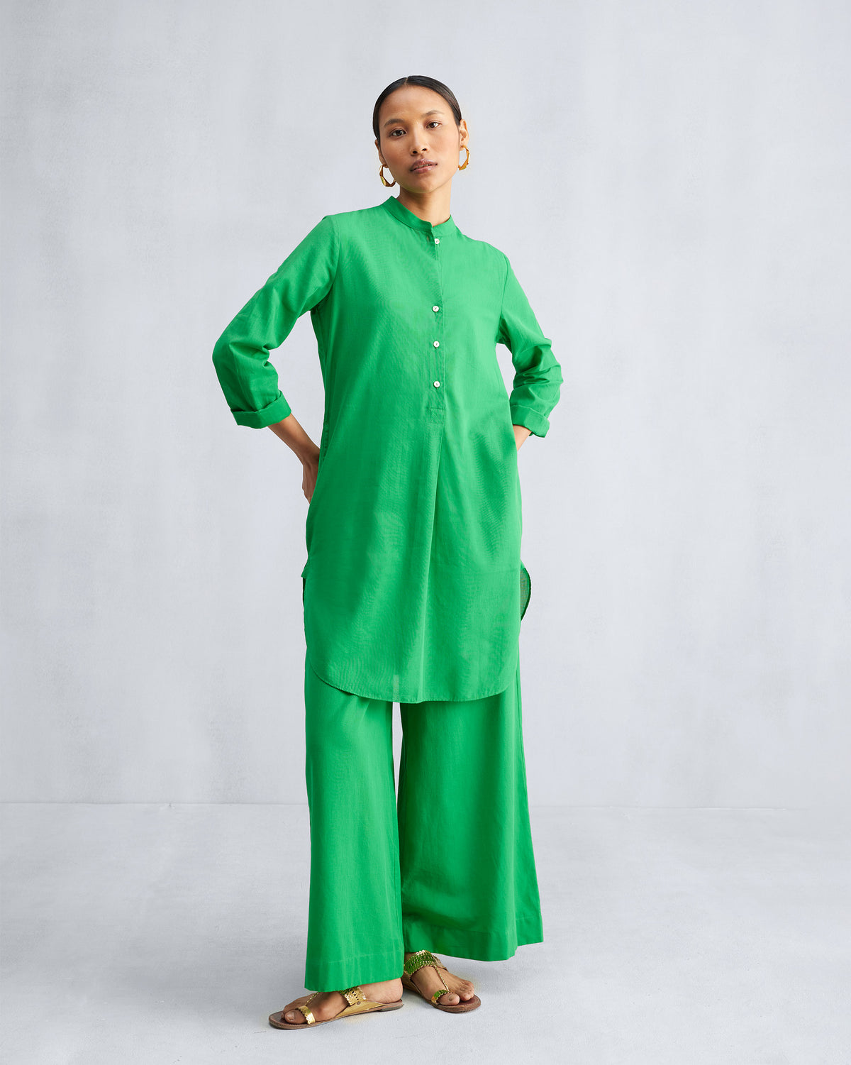 Person standing in the Basic Mid Length Kurta in green, with hands at the hips.