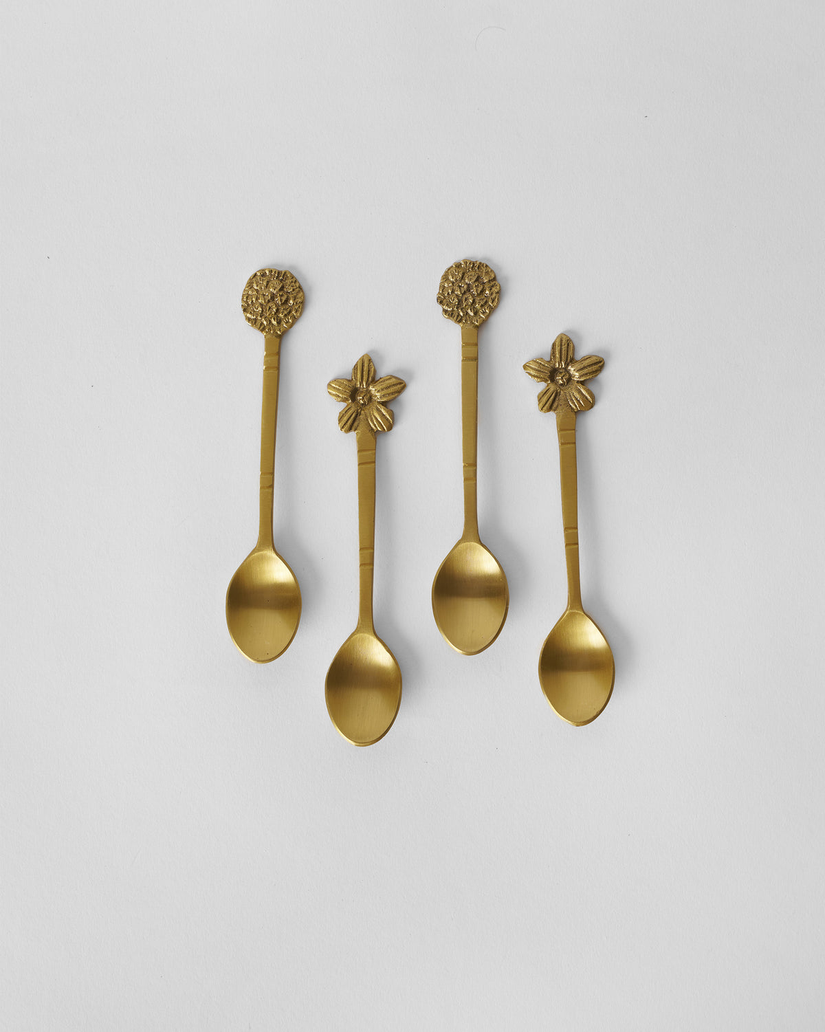 Set of four gold Bloom Coffee Spoons with flower and blossom handle tops.