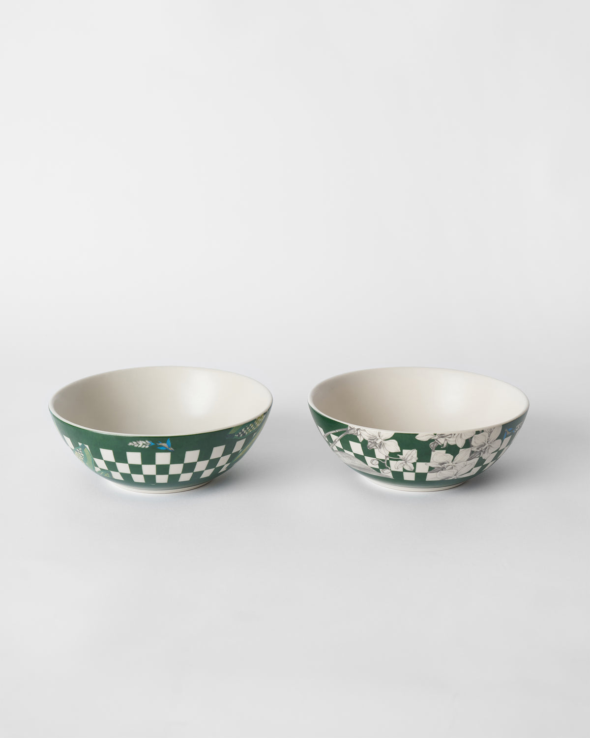 Pair of green Reesha vegetable bowls with checkered bands and white florals.