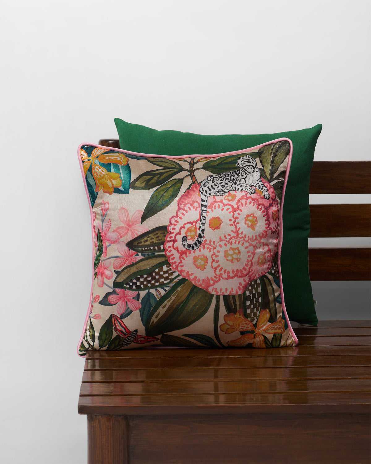 Buransh Cushion Cover with pink flowers and pink piping.
