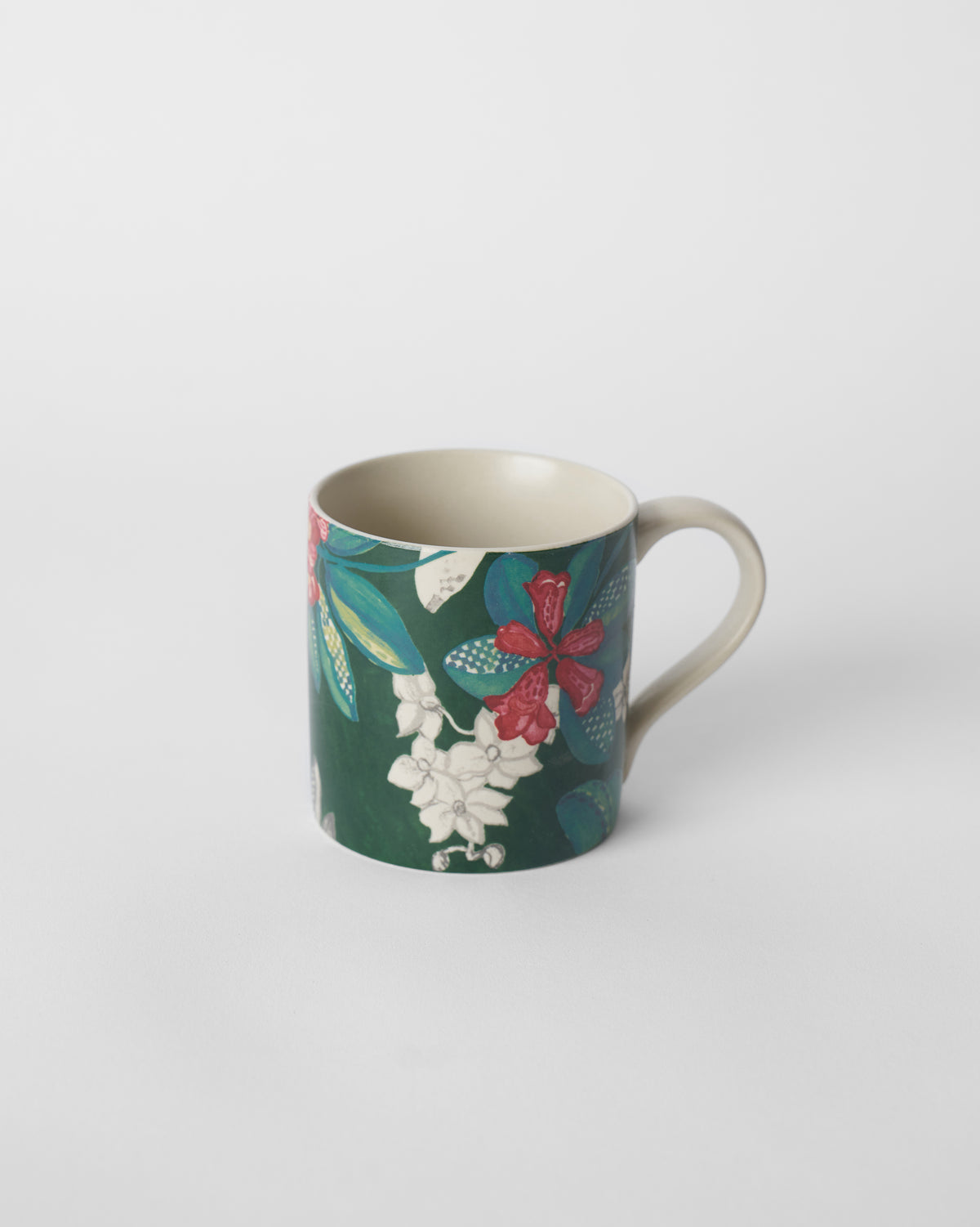 Deep green straight mug with red buransh blooms and a cream handle.