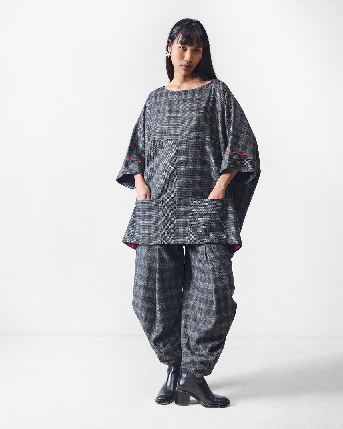 Black and charcoal check Weekend Trousers worn in a matching set.