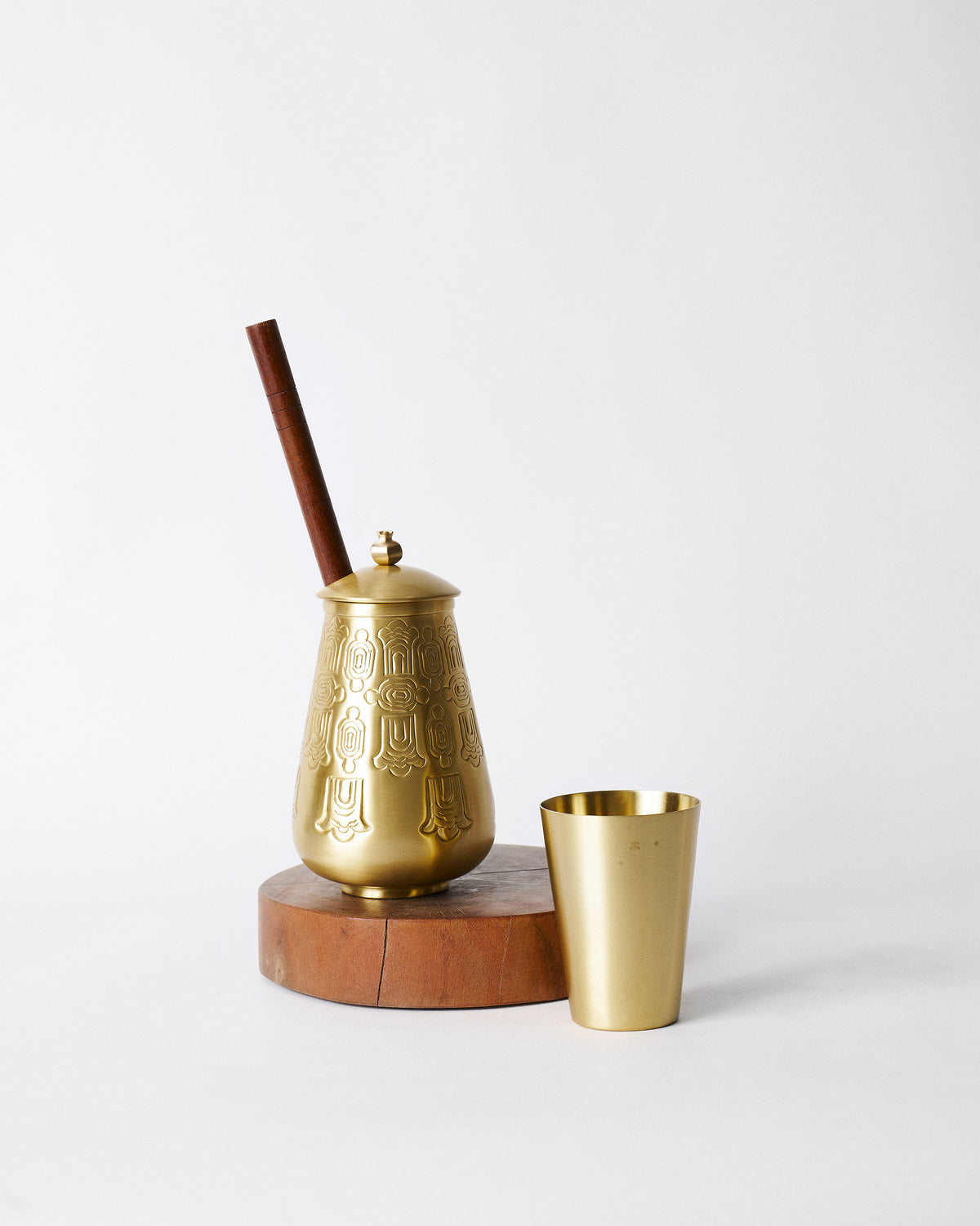Heritage Churn Set with an embossed brass vessel and matching tumbler.