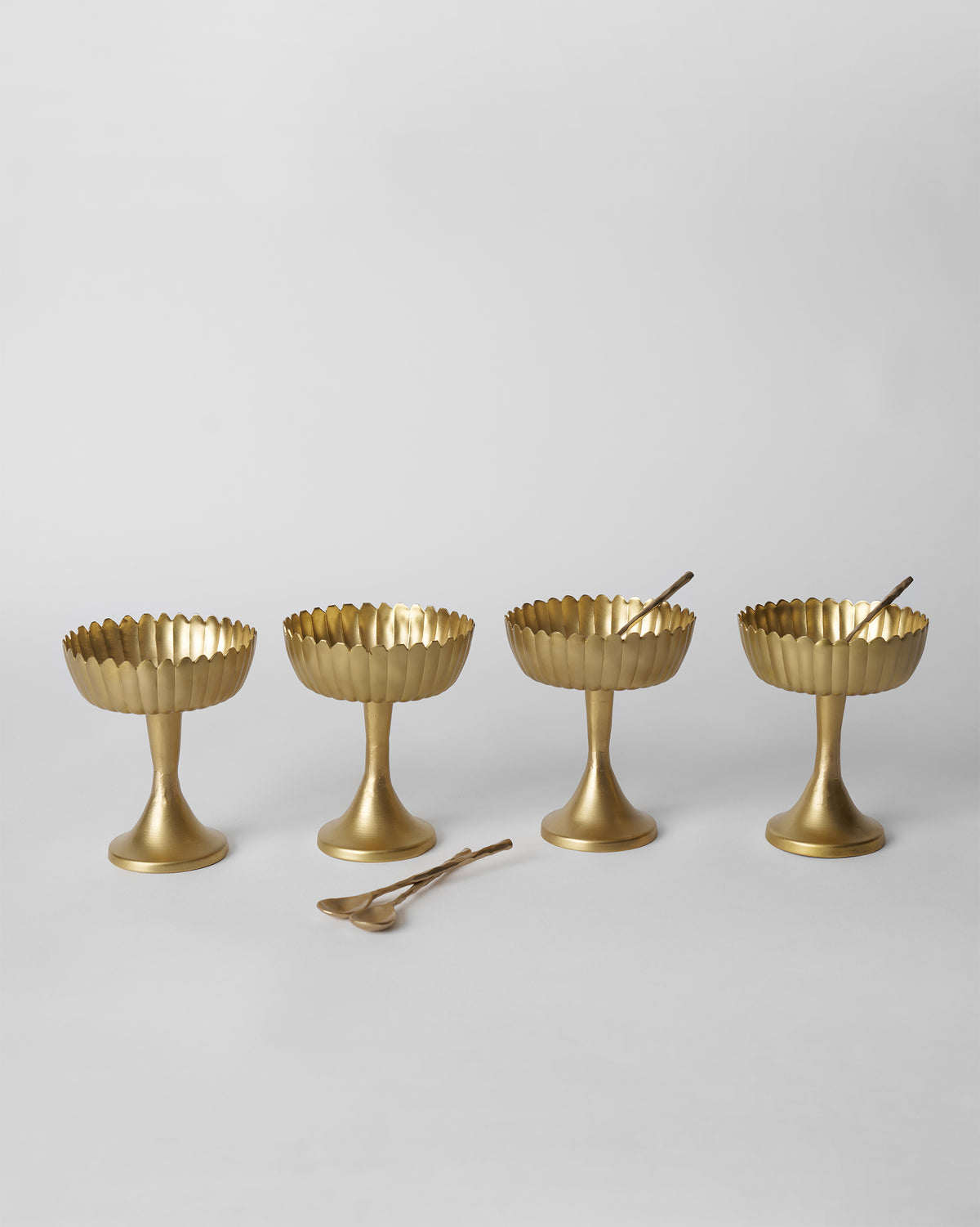 Set of four gold Dhaara Gelato Cups with matching spoons.