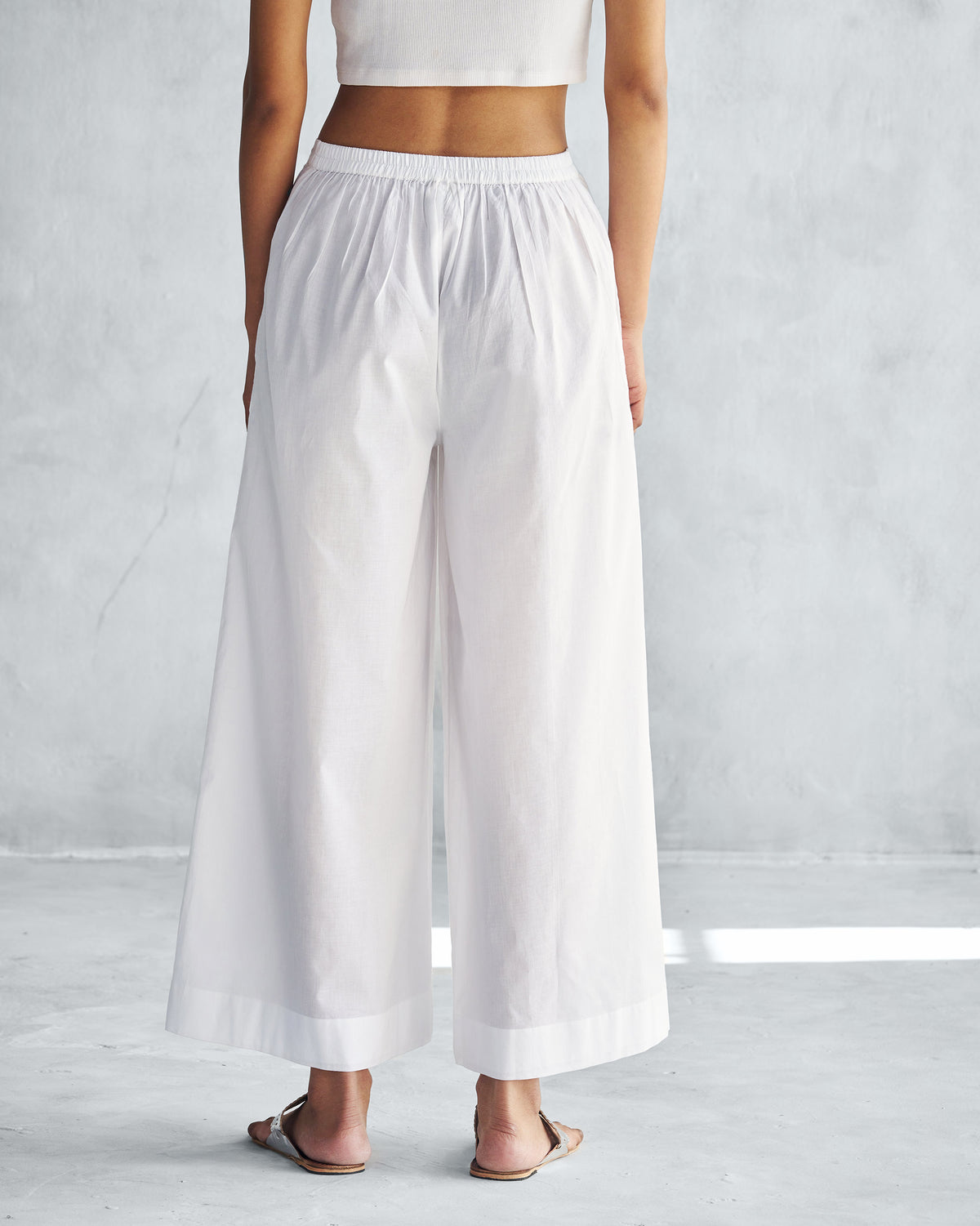 Back of white Basic Pyjamas worn by a person.