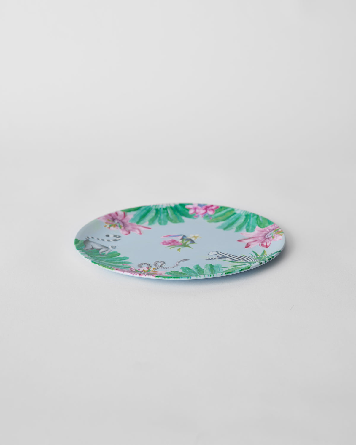 Side view of a Toucan Bamboo quarter Plate with a tropical flower border.