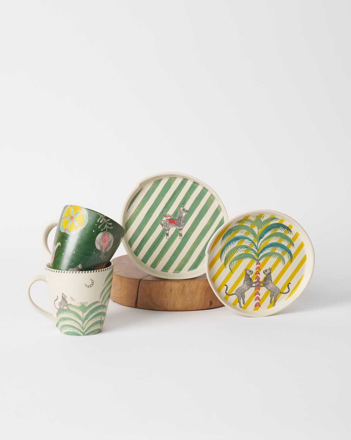 Plates and mugs from the Teatime set, with palm and leopard motifs.