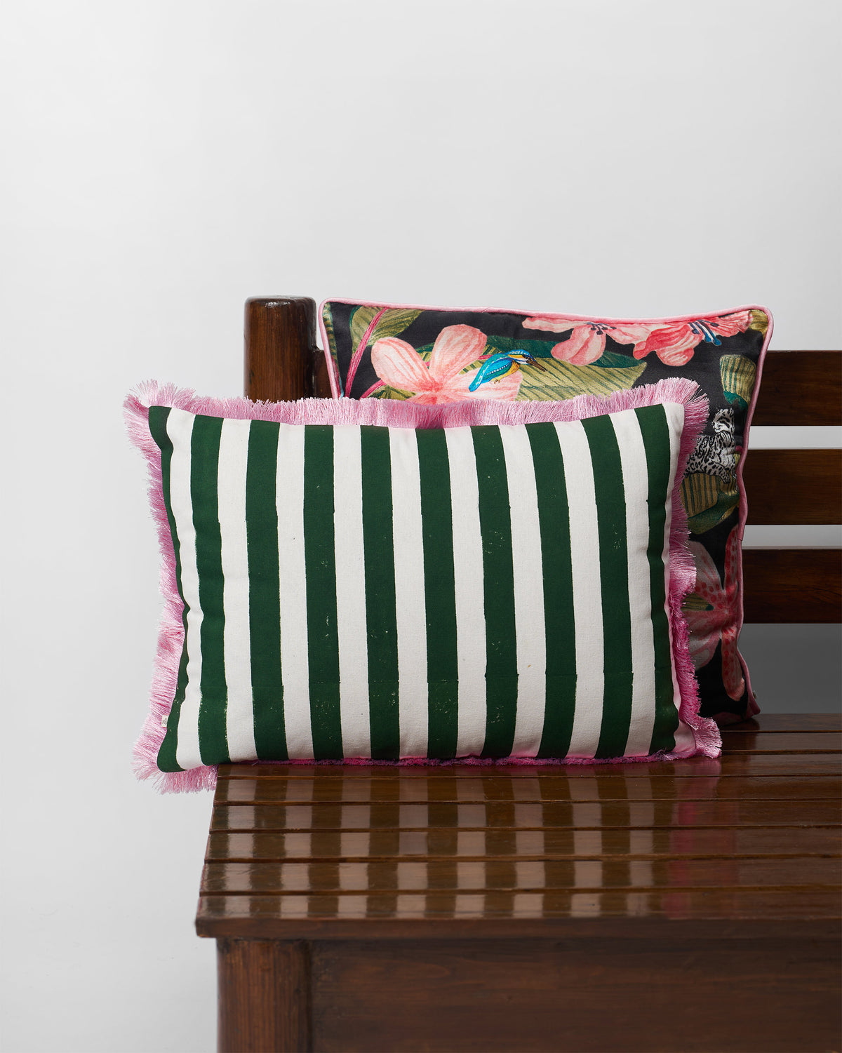 Kinaara Cushion Cover in green and white stripes with pink fringe.
