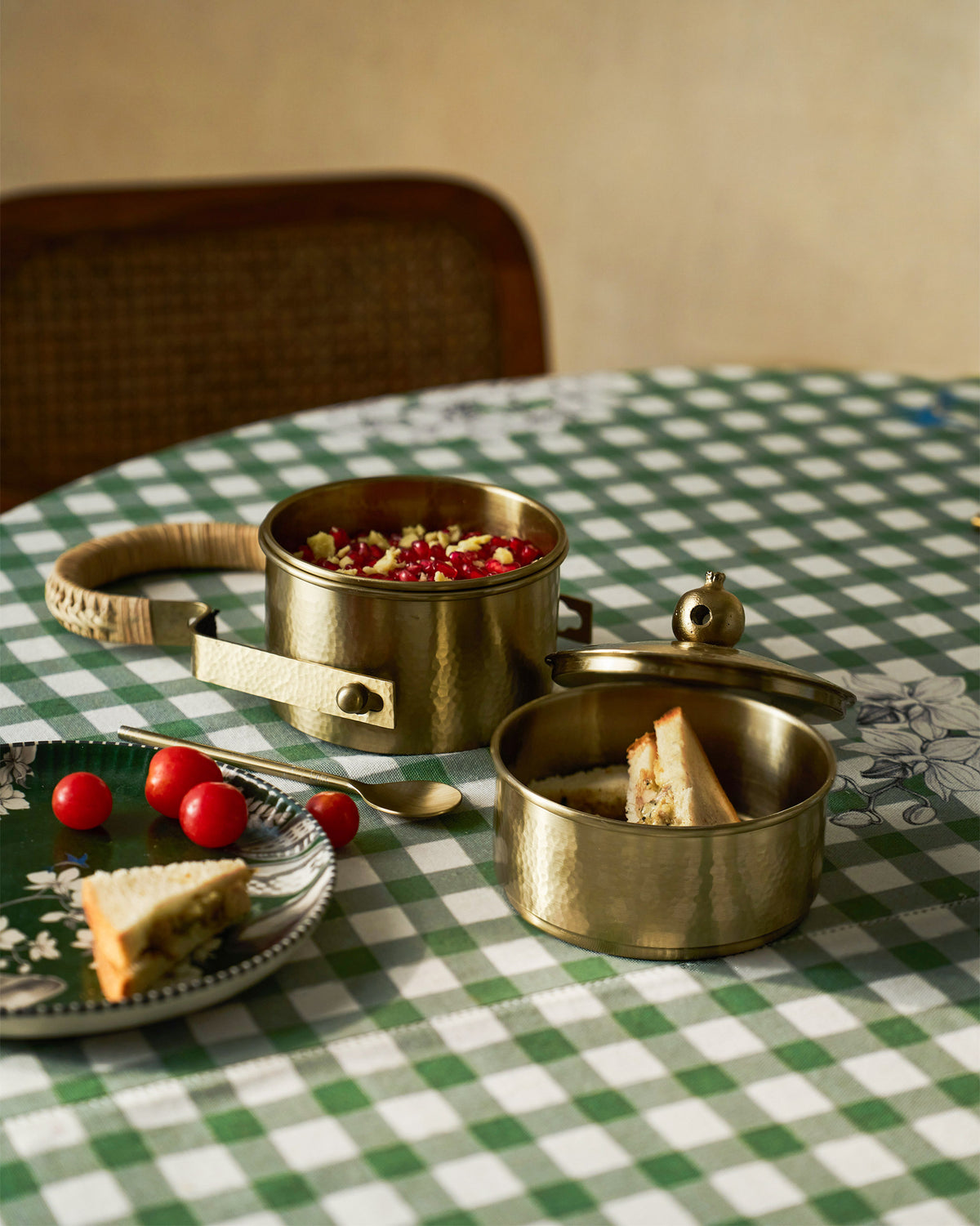 Gold Chand tiffin box open with food on a table.