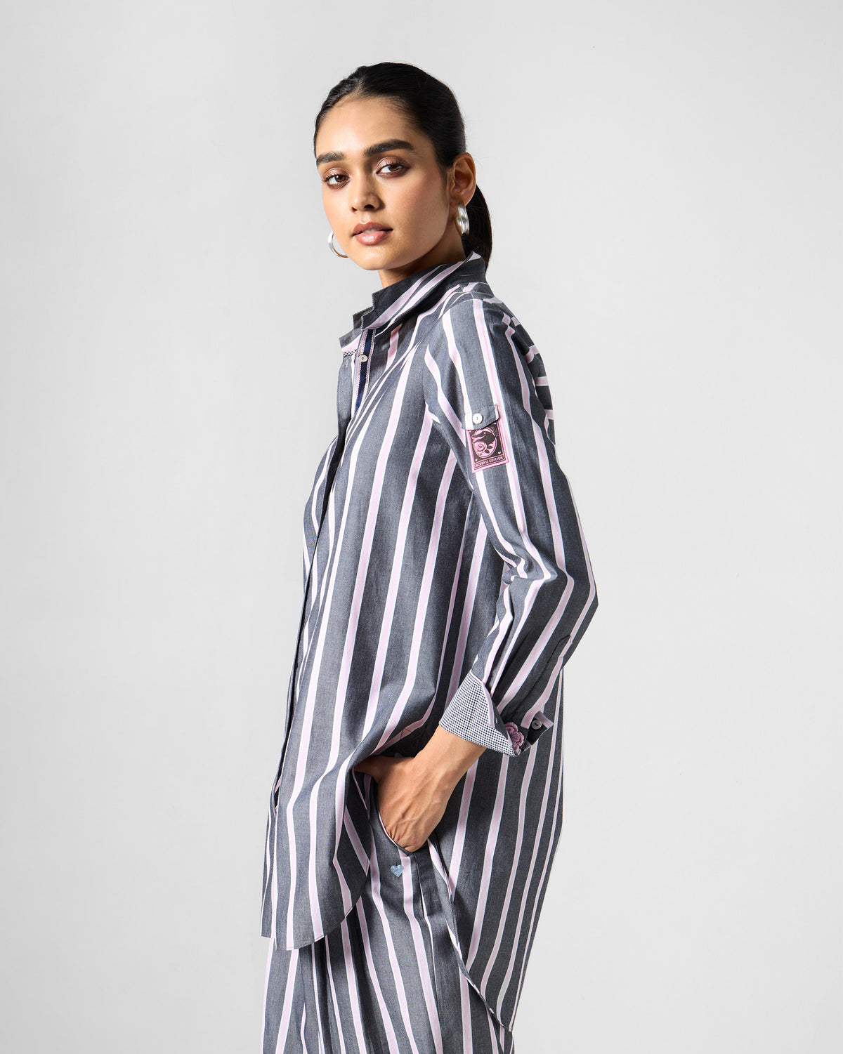 Side view of a charcoal and pink striped Trench shirt.