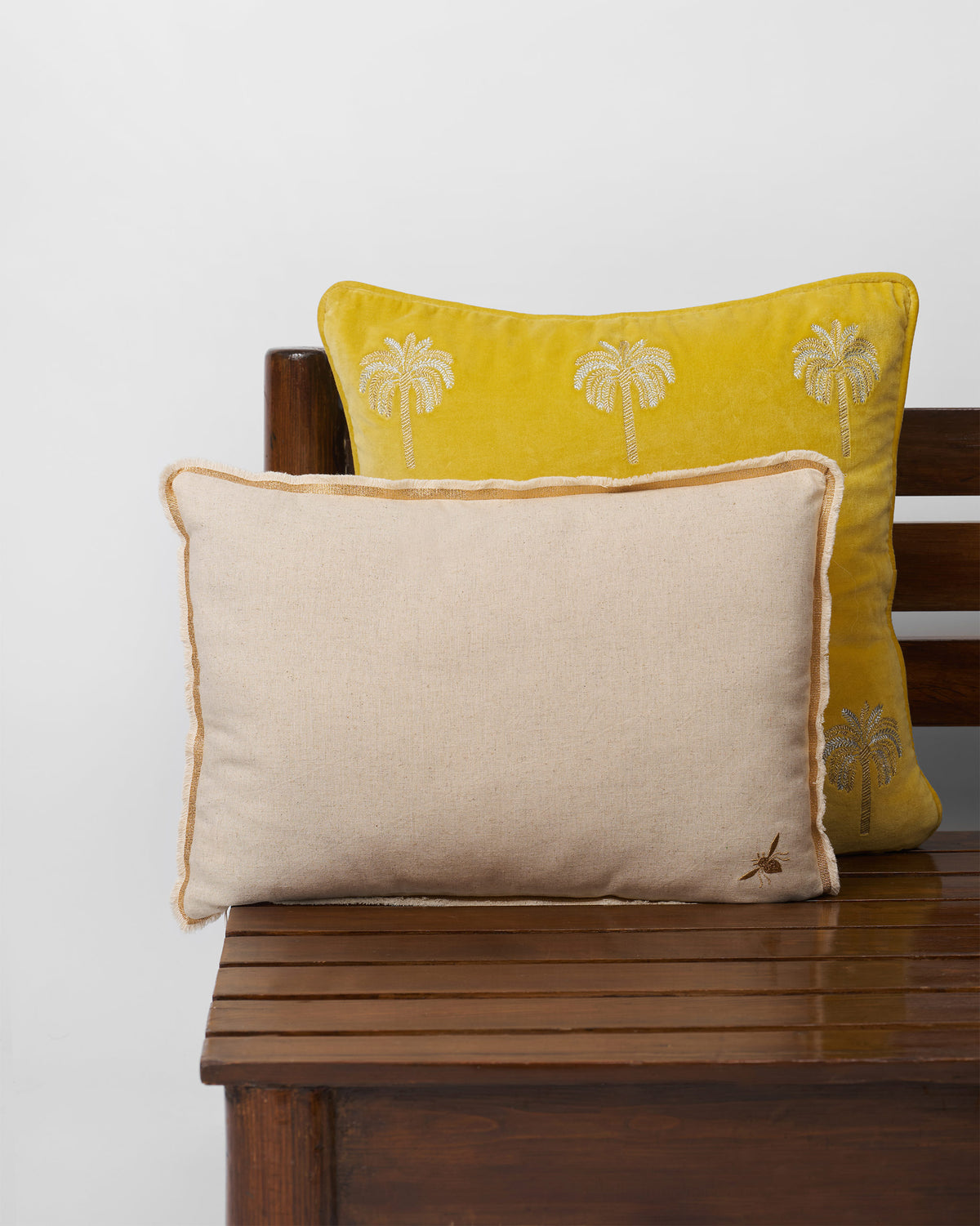 Back of the Madhu cushion cover with a small gold bee in one corner.