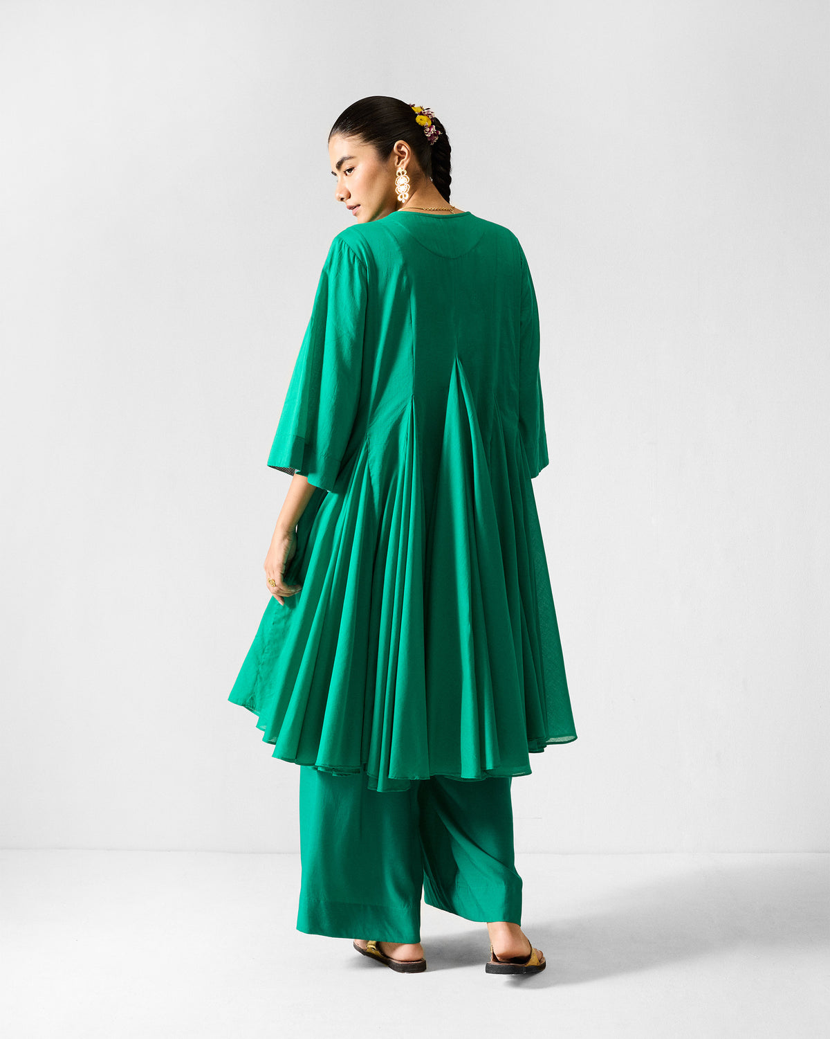 Back of the Gusset long kurta set worn by a person, showing its pleated back panels.