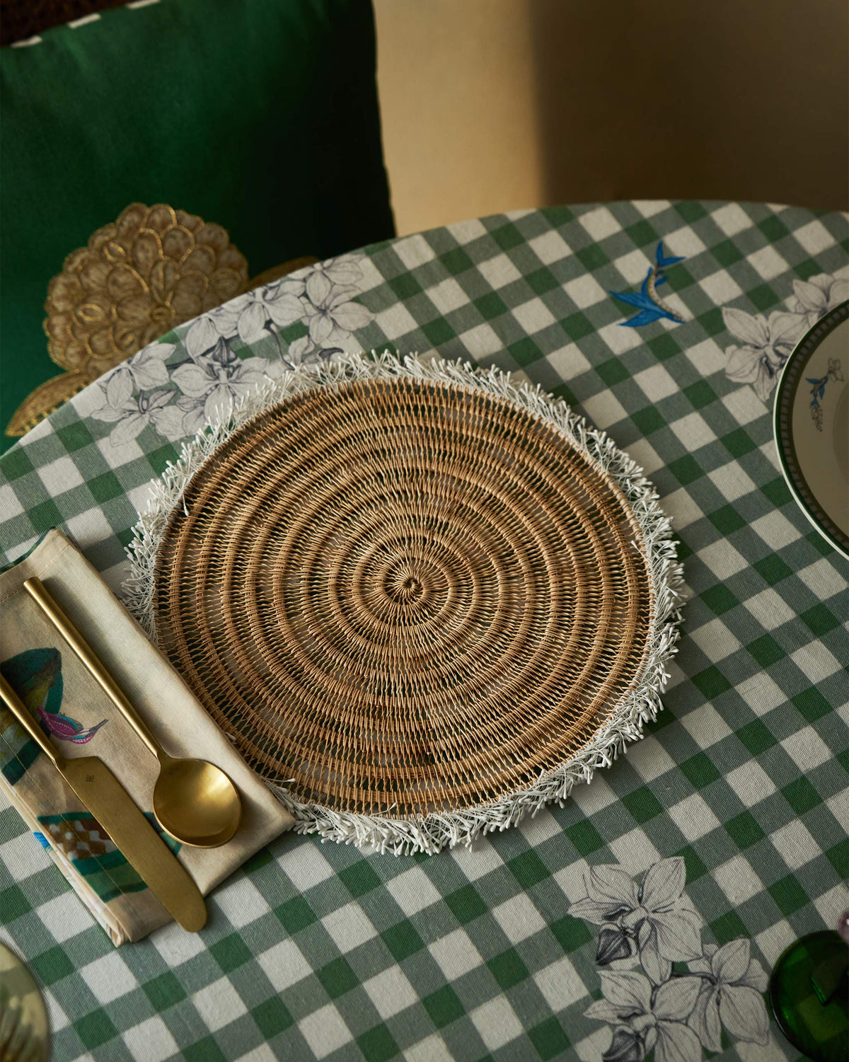 Kaveri Placemat with a fringed edge, shown on a dining table.