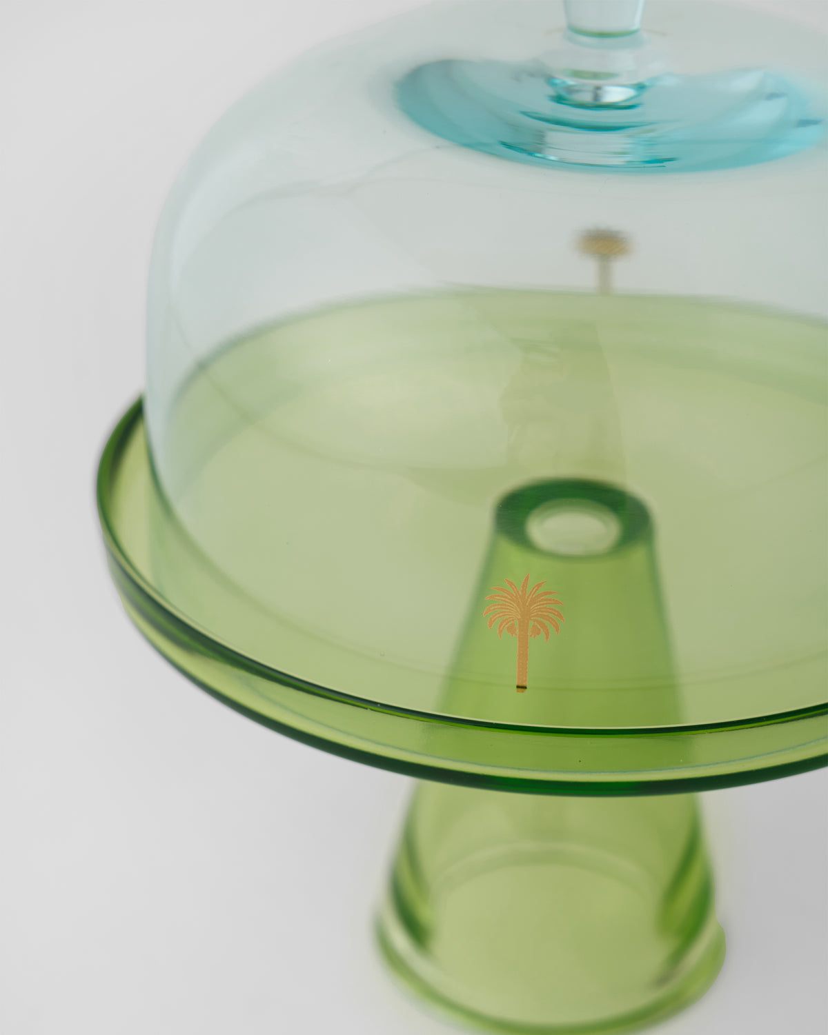 Close-up of the Vatika cake stand where the blue dome meets the green plate.