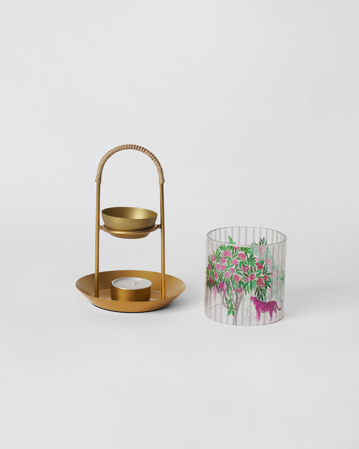 Kandy diffuser stand beside its pink tiger illustrated glass sleeve.