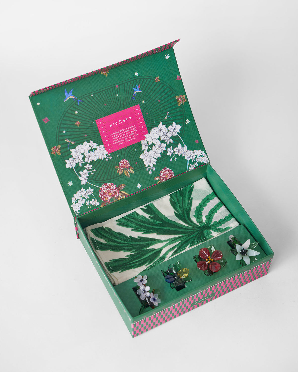 Open Vanika Gift Set box with green and white napkins and flower napkin rings.