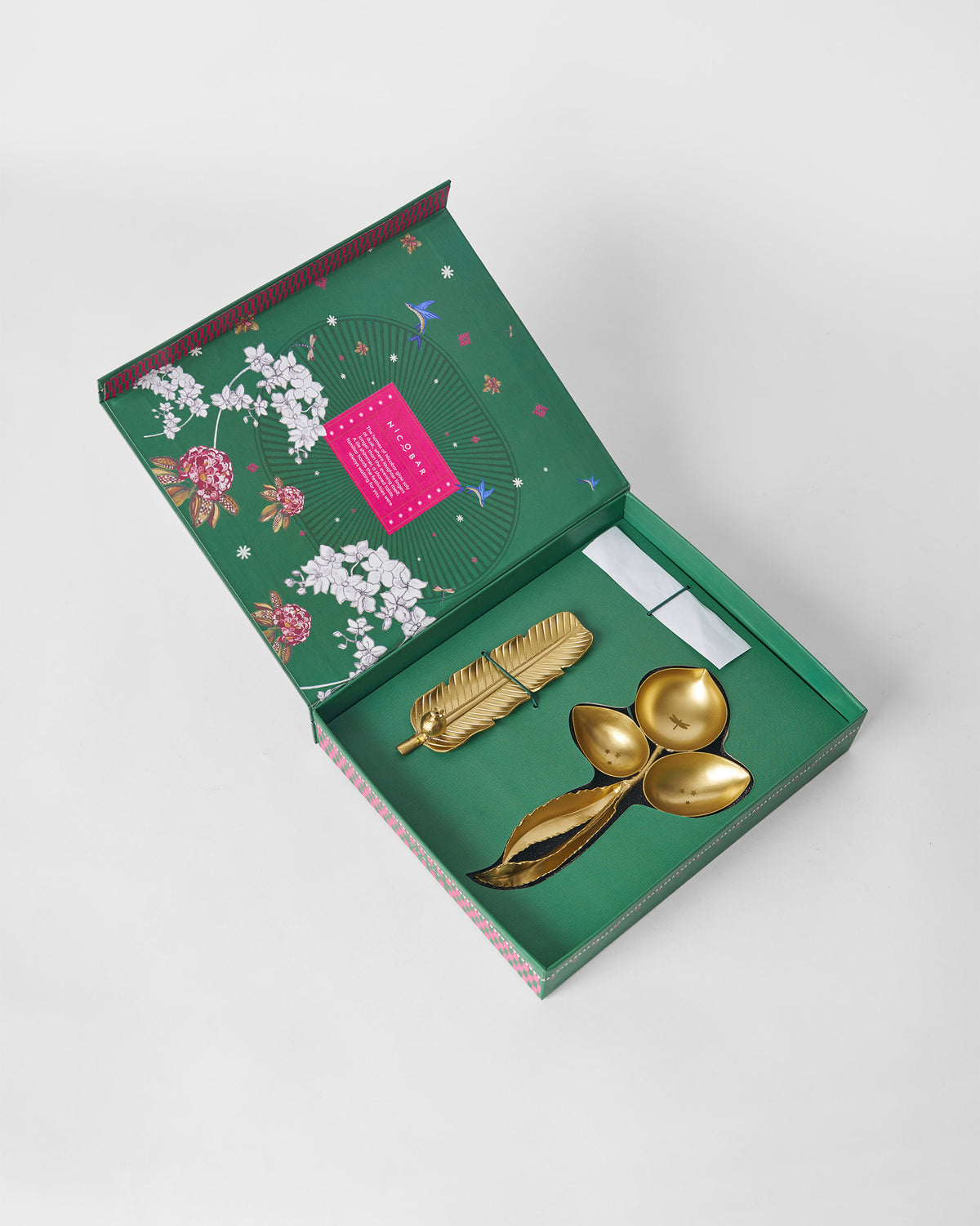 Taal brass pieces packed in an open green Nicobar gift box.
