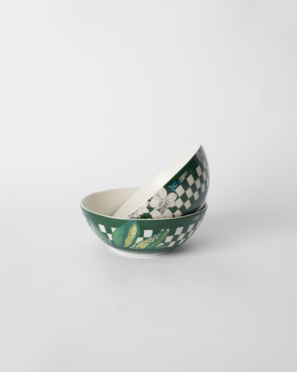 Nested Reesha vegetable bowls showing cream interiors and green floral exteriors.