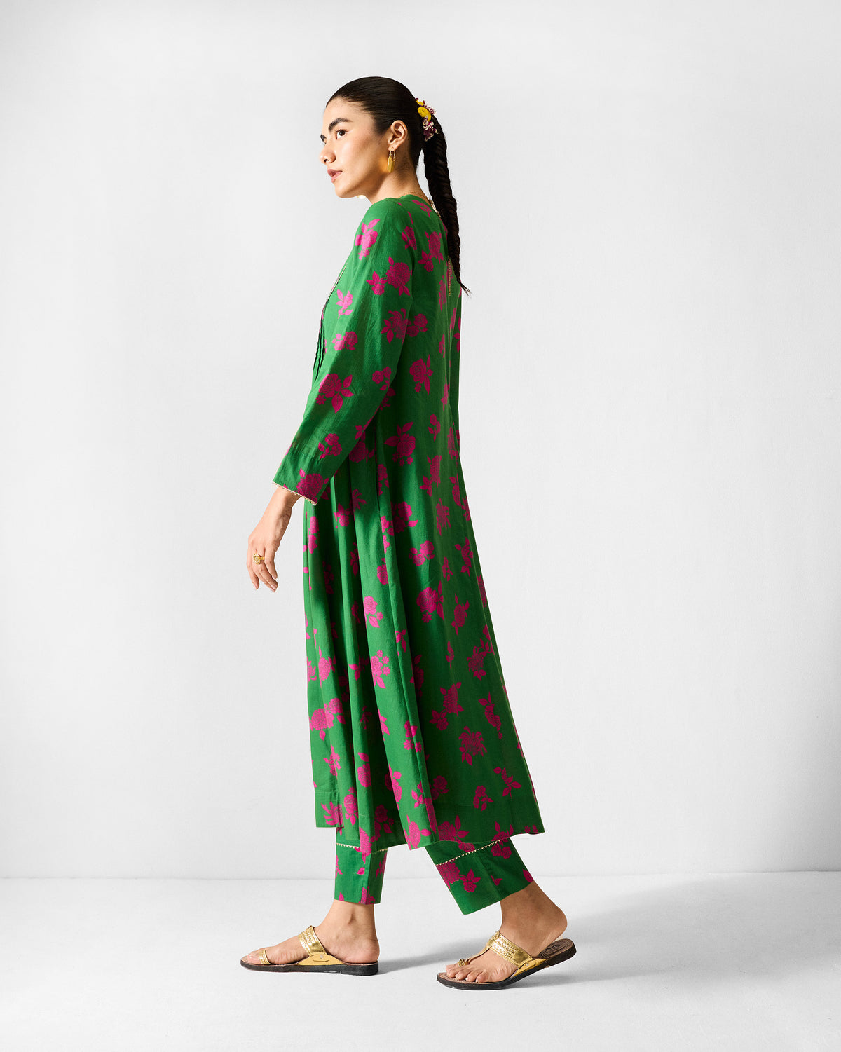 Side view of a green Ayat kurta set with pink florals and gold cuff trim.