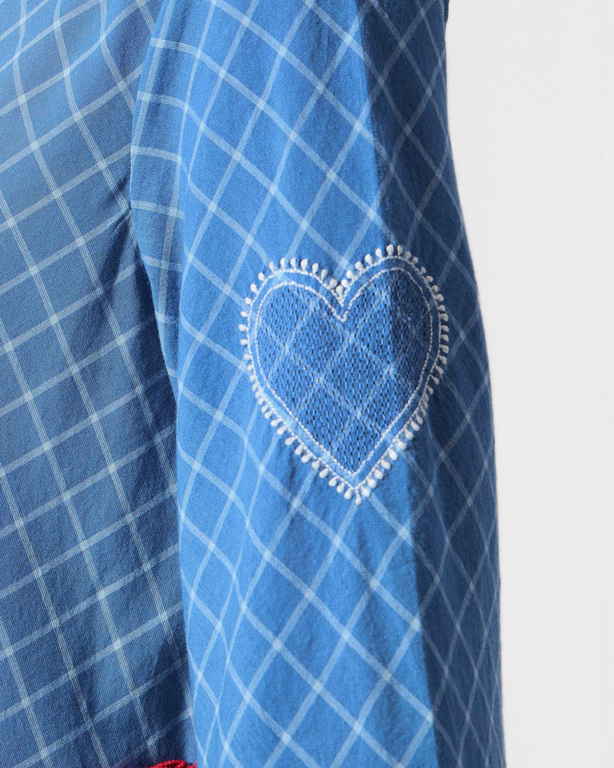 Close-up of the Giri kurta sleeve showing a heart embroidered in white stitching.