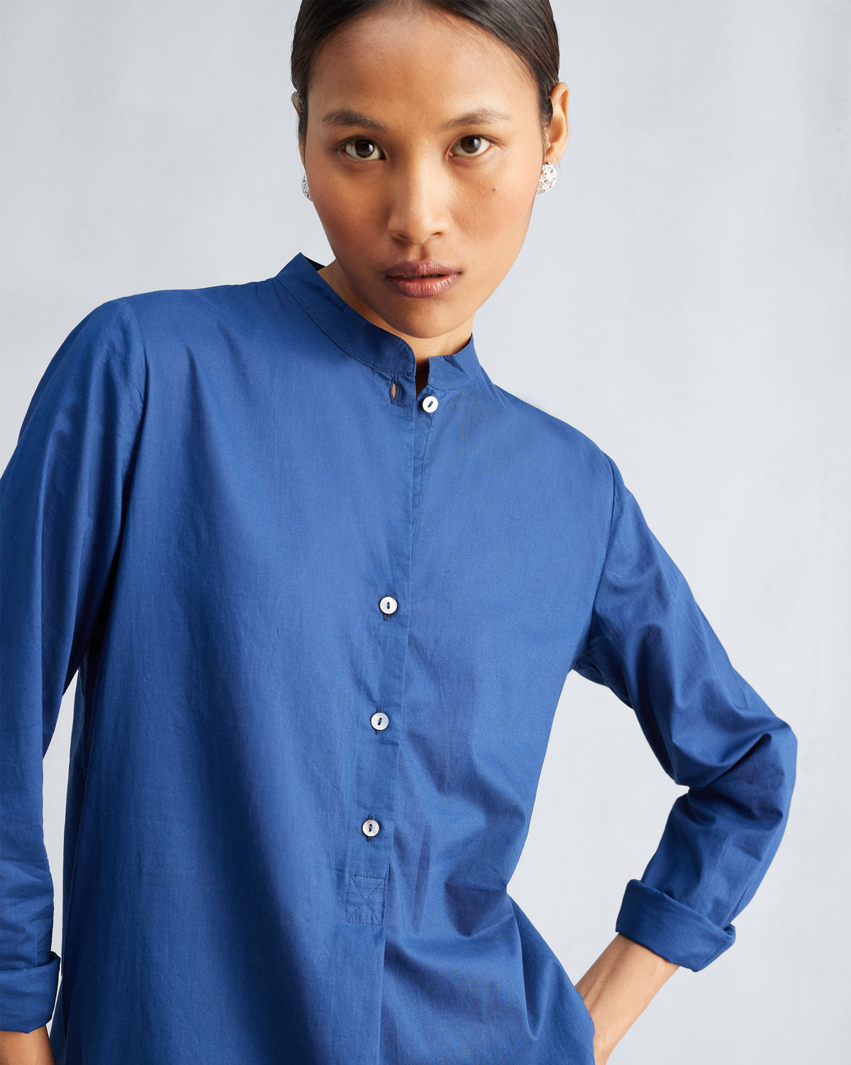 Close-up of the navy kurta mandarin collar and short button placket.