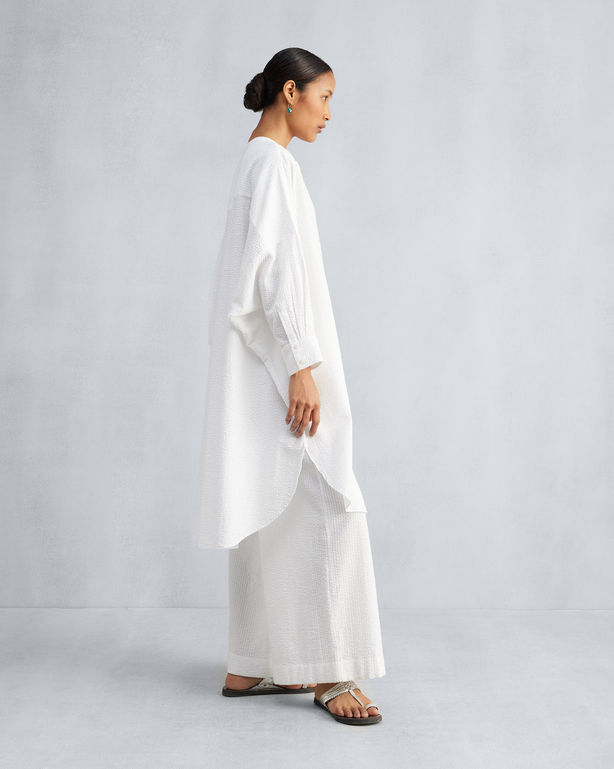 Side view of a white Lazy Sunday tunic set with a high-low hem.