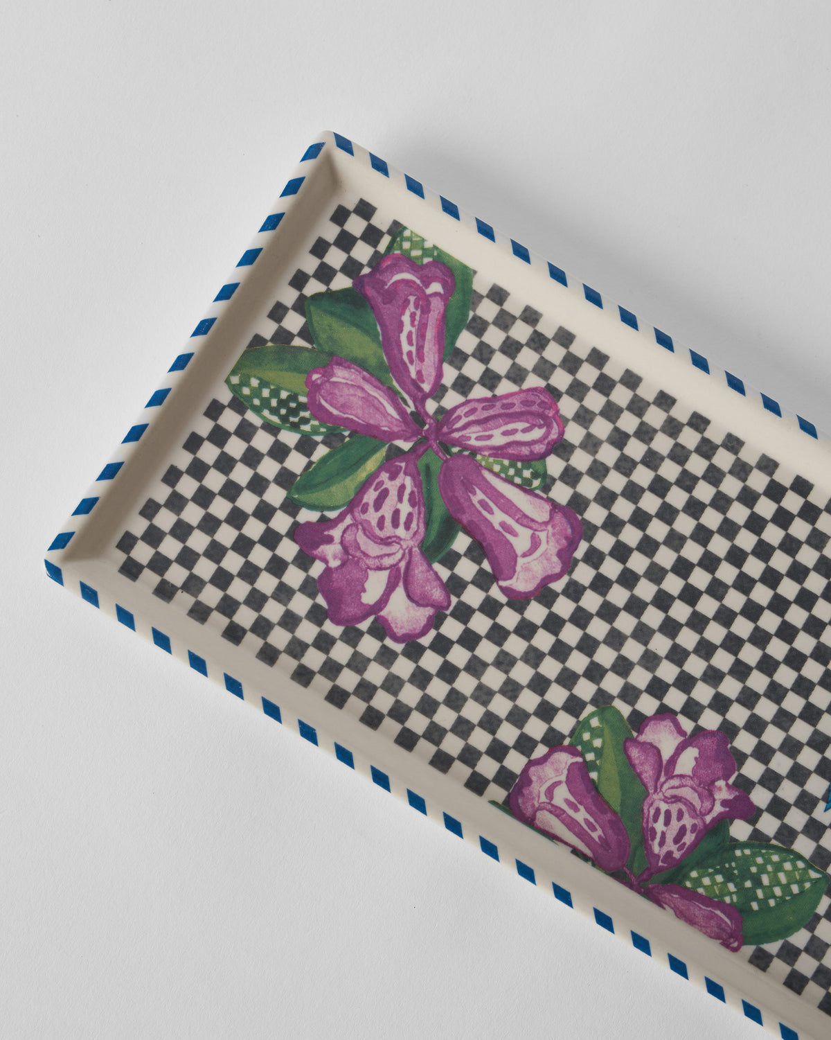 Close-up of a Buransh Cookie Tray with purple blooms on a checkered base.