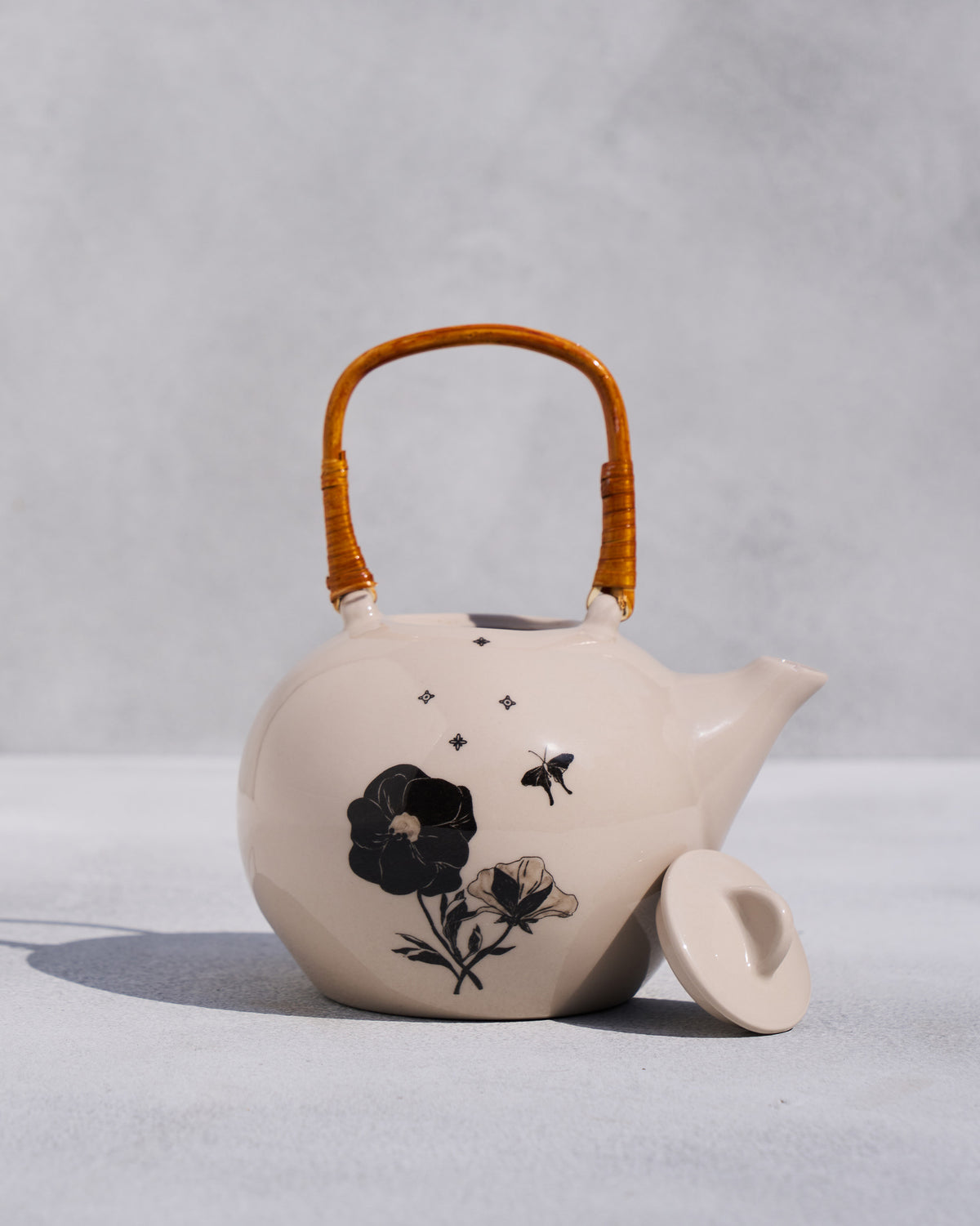 Poppy teapot with its ivory lid set aside, showing the open top.