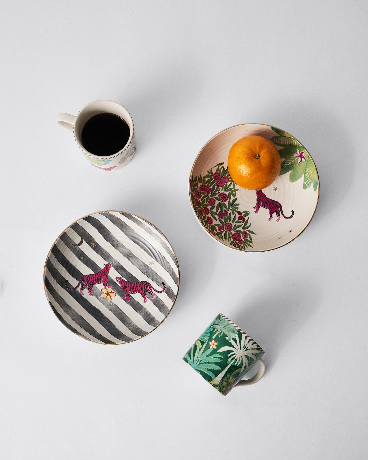Ceylon Comfort Set bowls with magenta tigers styled with coffee and fruit.