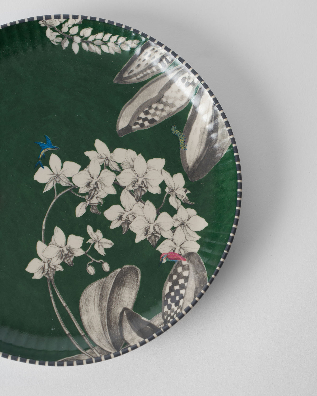 Close-up of Reesha Quarter Plate - Green showing its white orchid print and grey leaves.