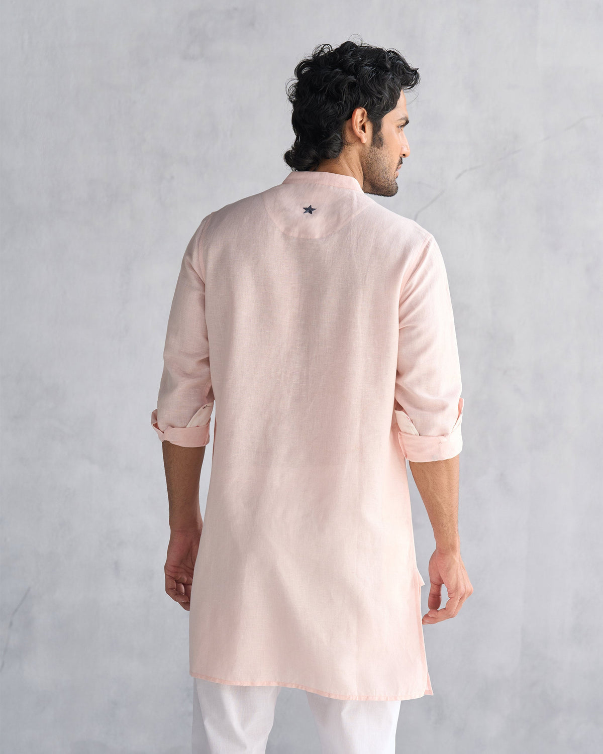 Back of a pink Chandni Chowk kurta with an embroidered star.