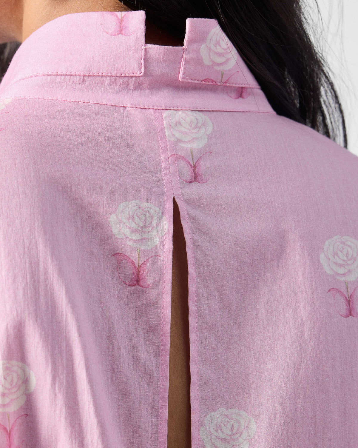 Close-up of the slit back neck on a pink floral tunic.