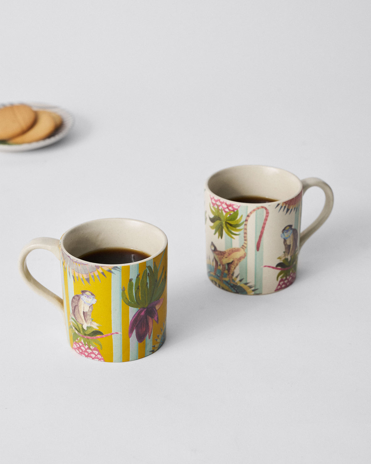 Pair of yellow and ivory Mahi Mugs from the Mahi Mug Set, placed side by side.