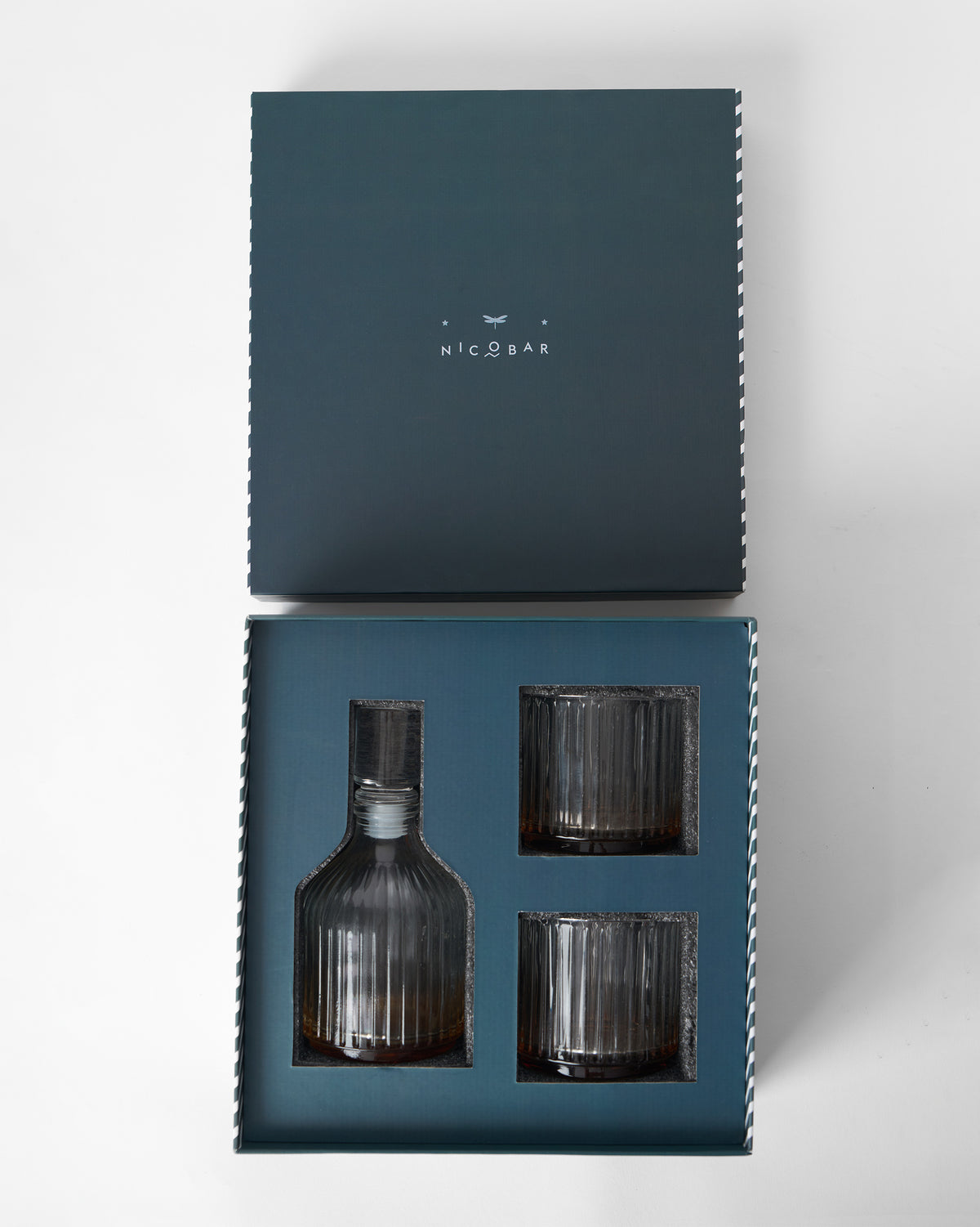 Tarang Bar Gift Set with its lid lifted off, showing the decanter and two ribbed glasses.